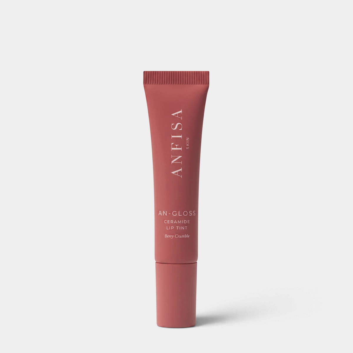 Shop Rescue Spa AN-GLOSS Ceramide Lip Tint in Berry Crumble, a moisturizing pink lip gloss in a squeeze tube.