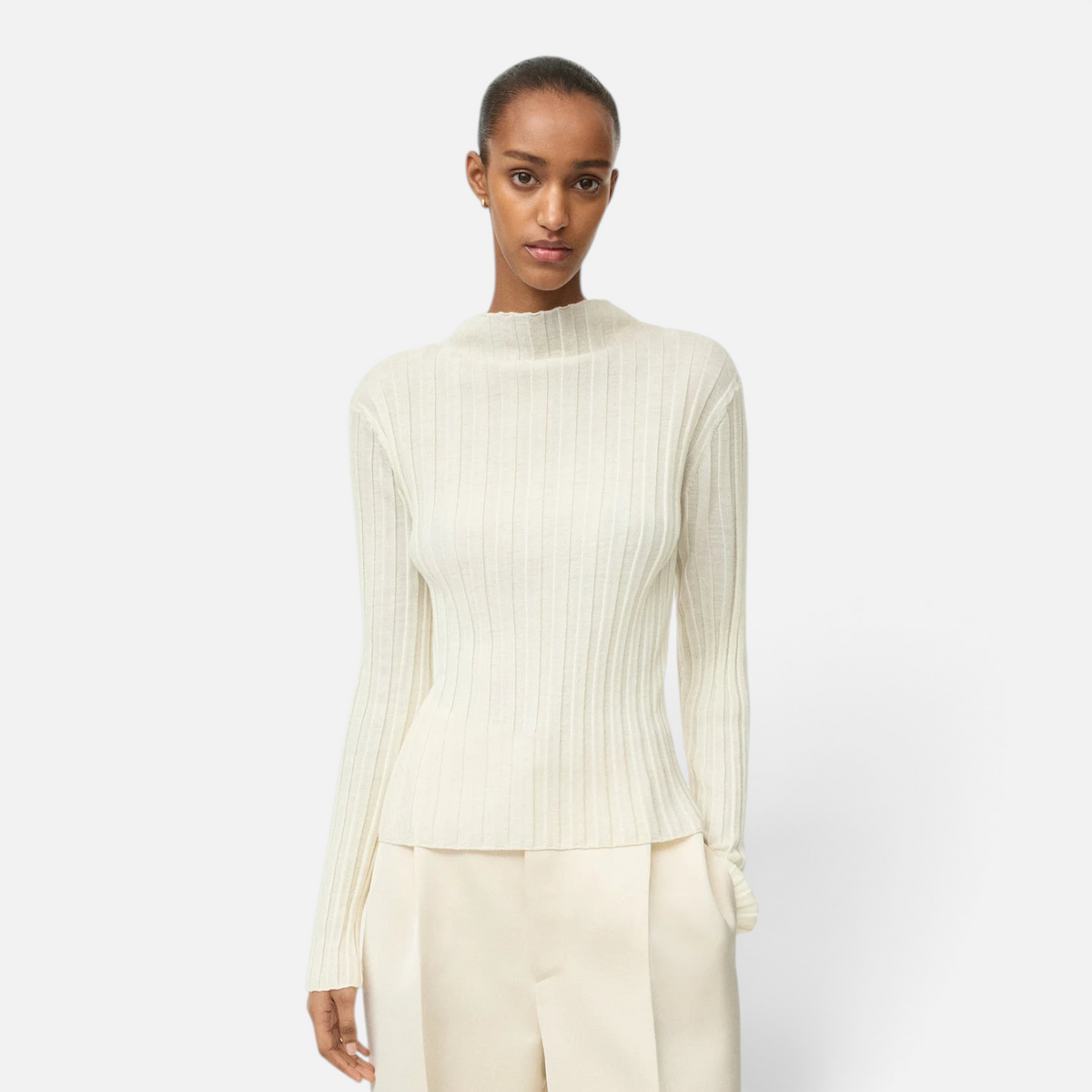 Model wearing a Shop Rescue Spa cream ribbed featherlight wool top with long sleeves and a mock neck