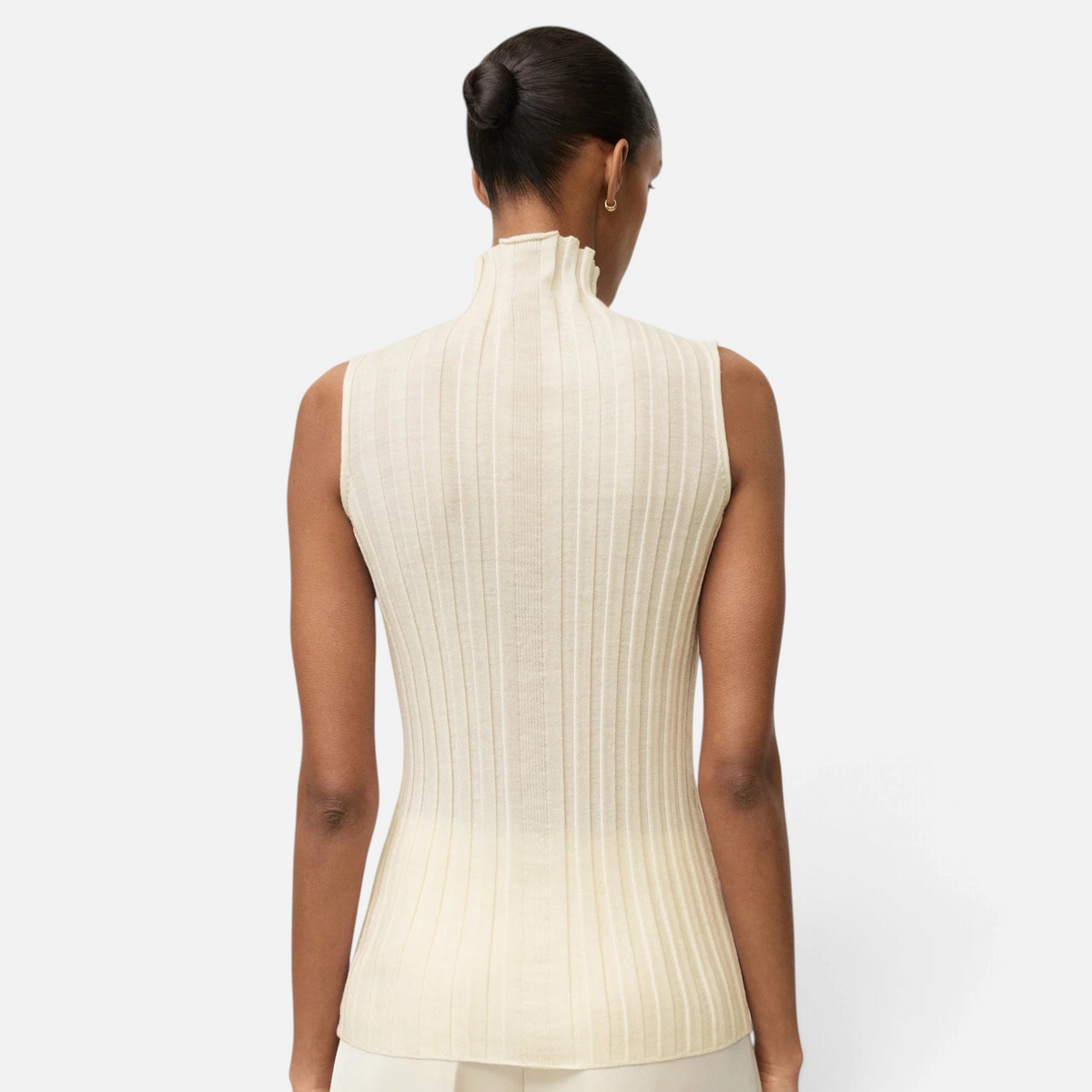Back view of a model wearing a Shop Rescue Spa cream ribbed wool turtleneck singlet with a slim fit.