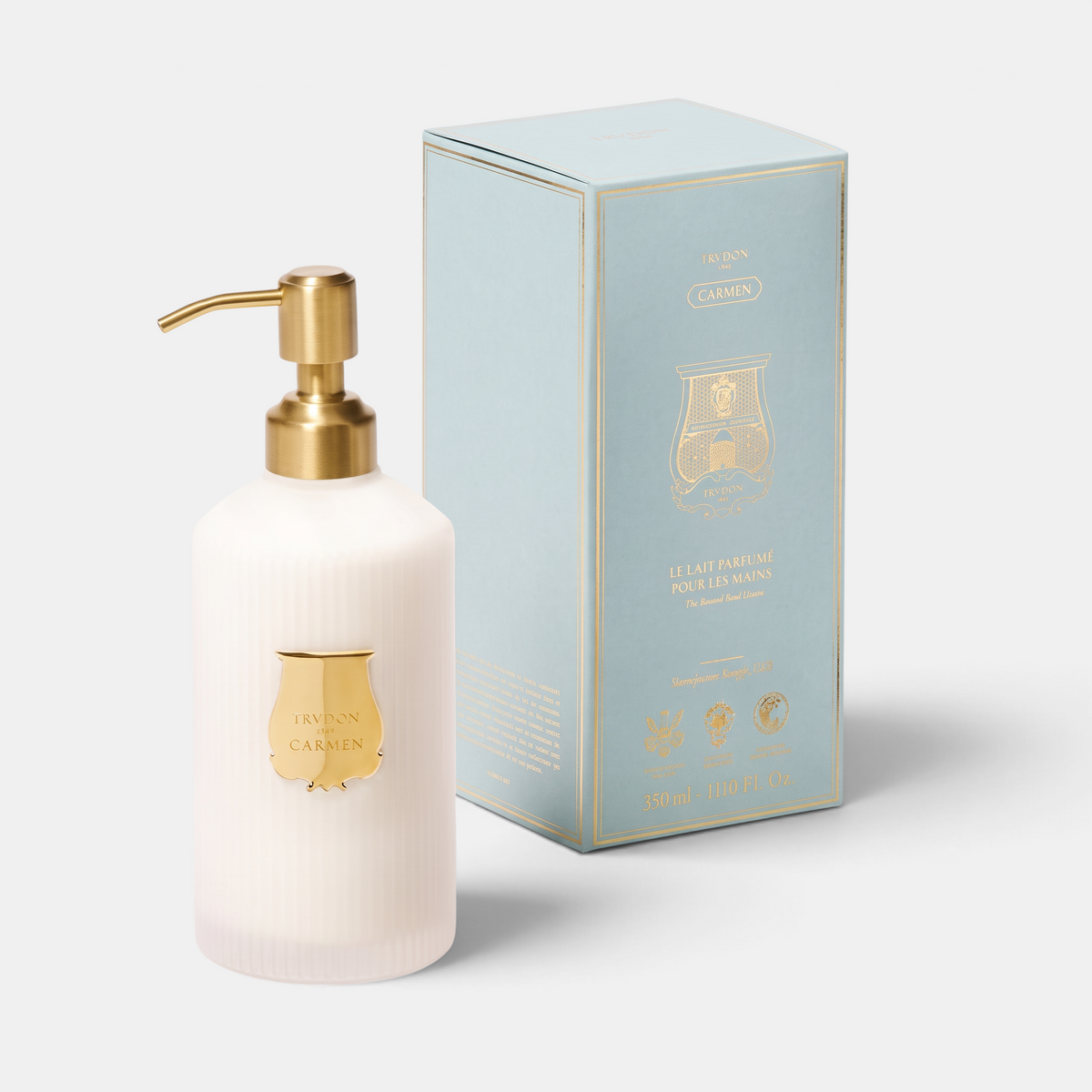 Shop Rescue Spa Carmen scented hand lotion in a white bottle with a gold pump and matching light blue gift box.