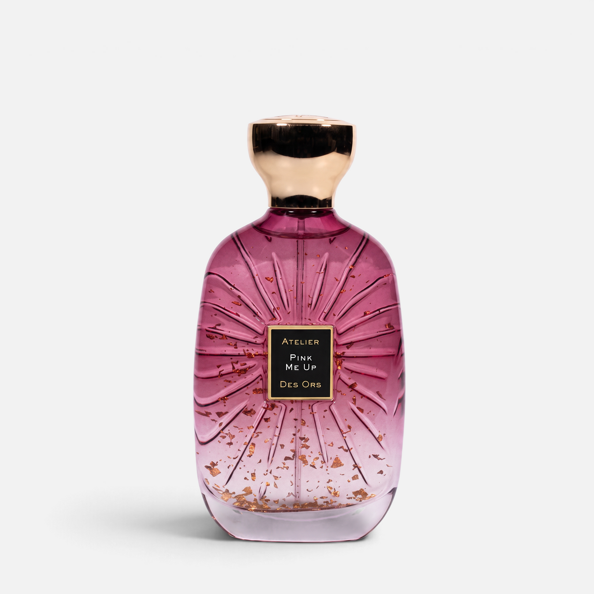 Shop Rescue Spa Pink Me Up perfume bottle with pink liquid and gold flakes, featuring a gold cap and glass texture.