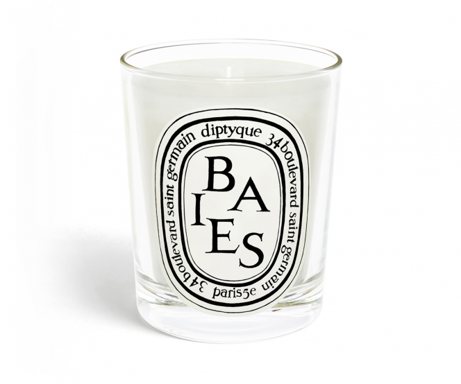 Diptyque candle in a glass container with &