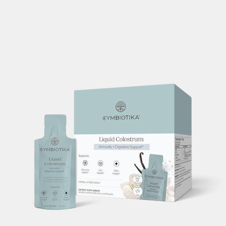 Shop Rescue Spa Cymbiotika Liquid Colostrum supplement box and single packet with vanilla sea salt flavor