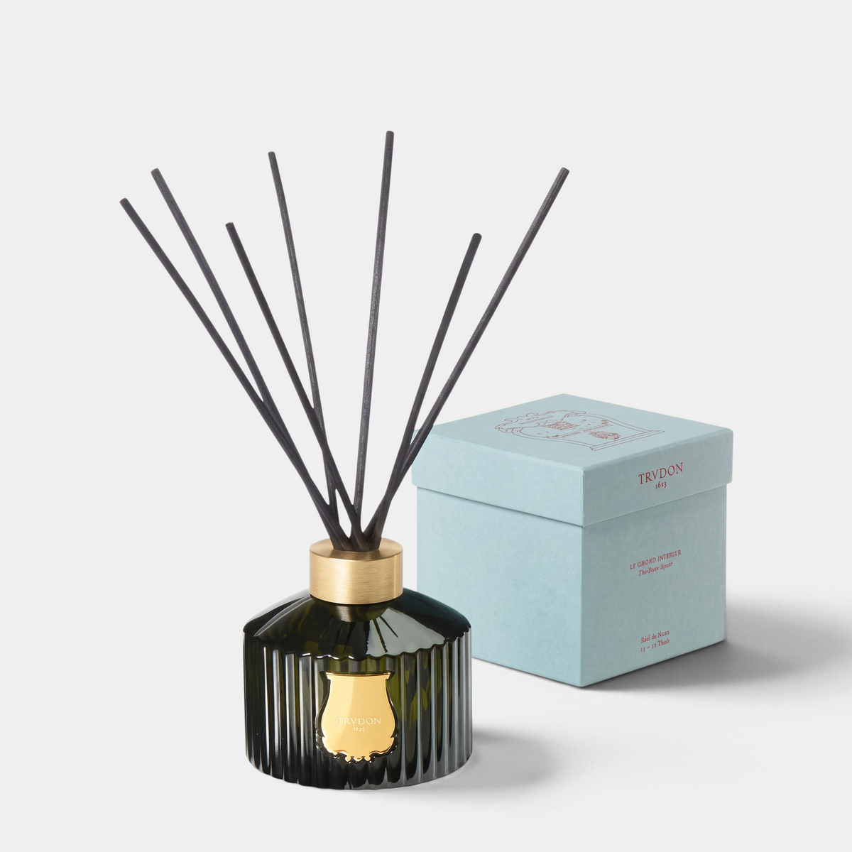 Shop Rescue Spa Le Grand Diffuser Ernesto with dark green fluted glass bottle, gold emblem, and black reed sticks.