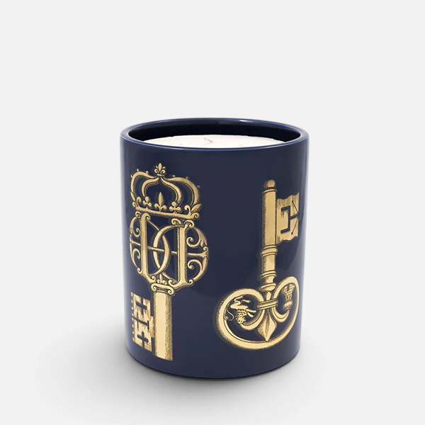 Shop Rescue Spa Fornasetti Chiavi scented candle in a navy blue ceramic vessel with ornate gold key illustrations.