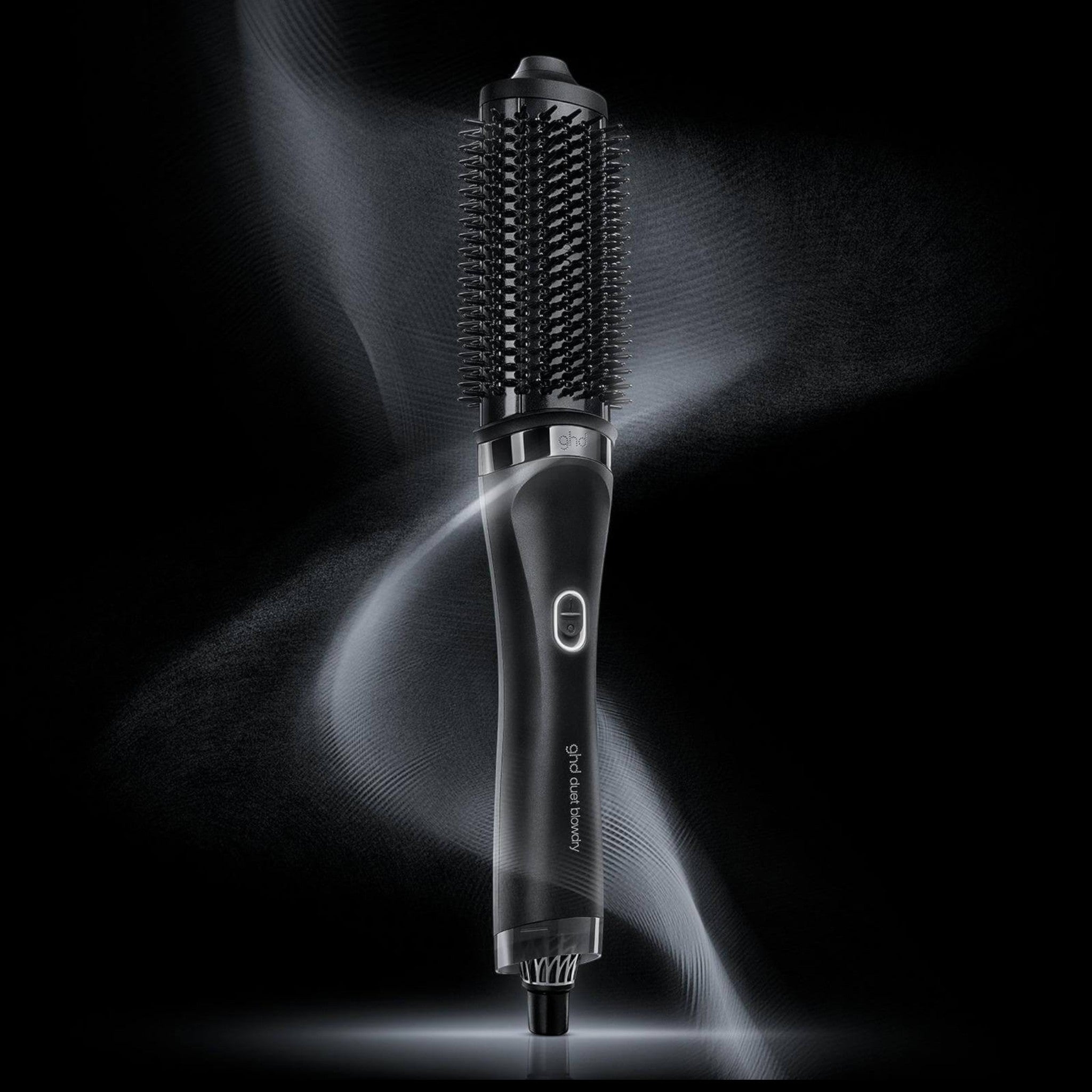 ghd Duet Blowdry hair dryer brush in black with sleek design and airflow effect on a dark background.