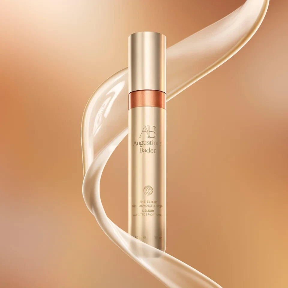 Shop Rescue Spa Augustinus Bader The Elixir anti-aging serum in a gold bottle with flowing liquid texture
