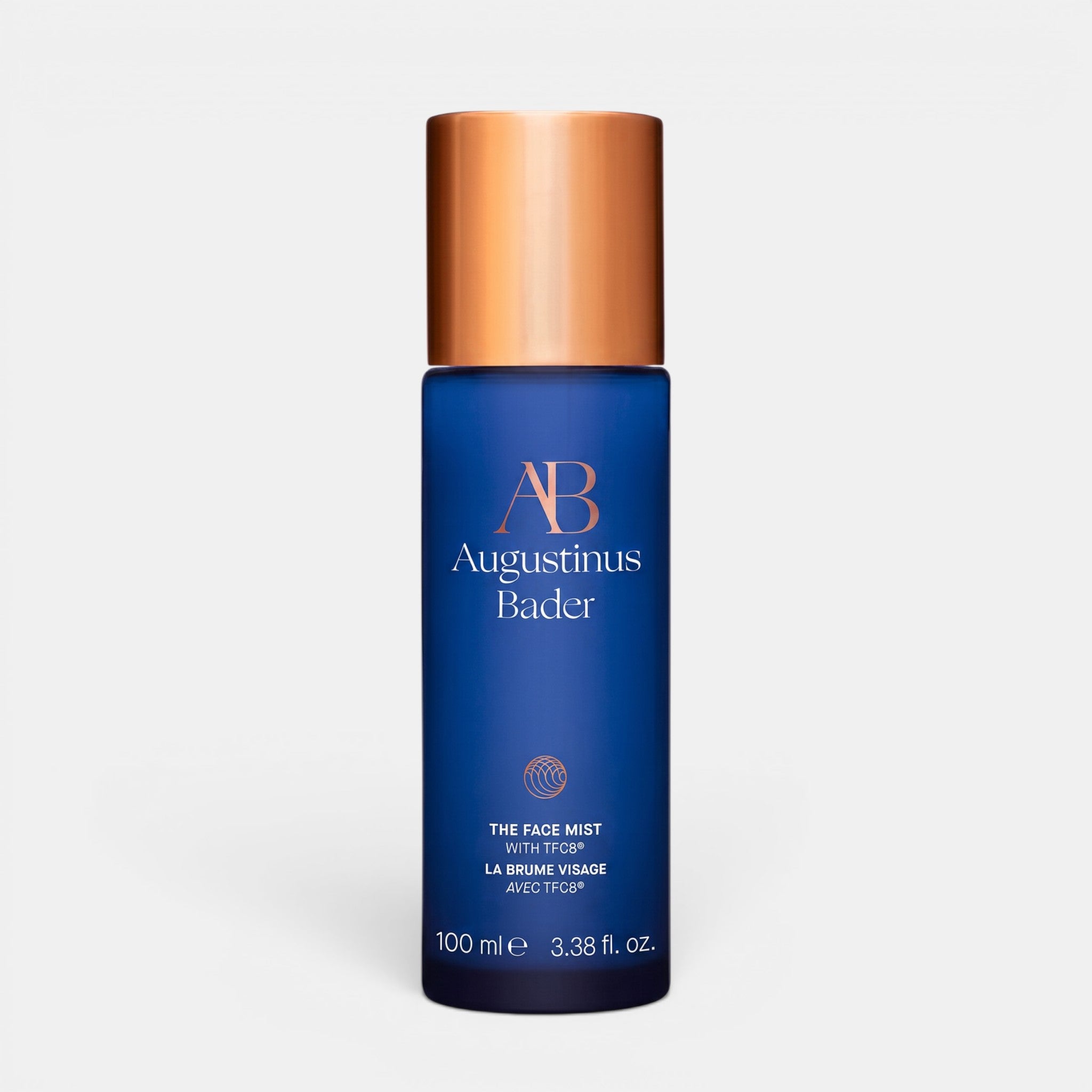 Shop Rescue Spa Augustinus Bader The Face Mist in a blue bottle with a metallic copper cap for hydrating skin.