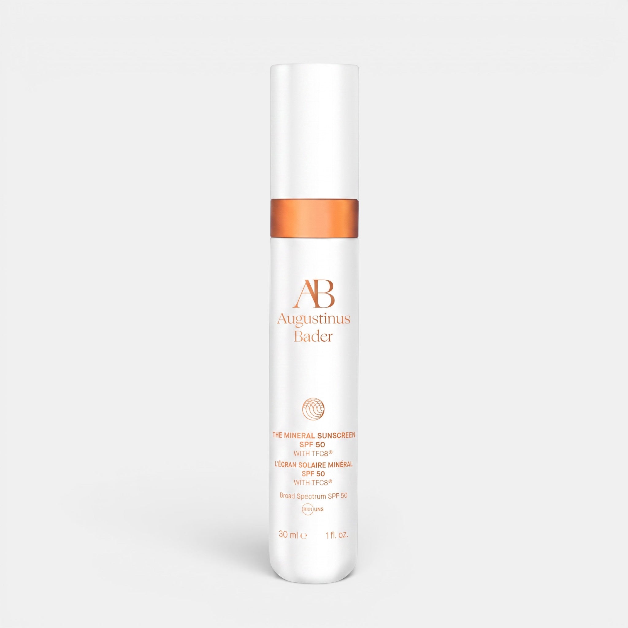 Shop Rescue Spa Augustinus Bader The Mineral Sunscreen SPF 50 in a white 30ml pump bottle with copper accents.