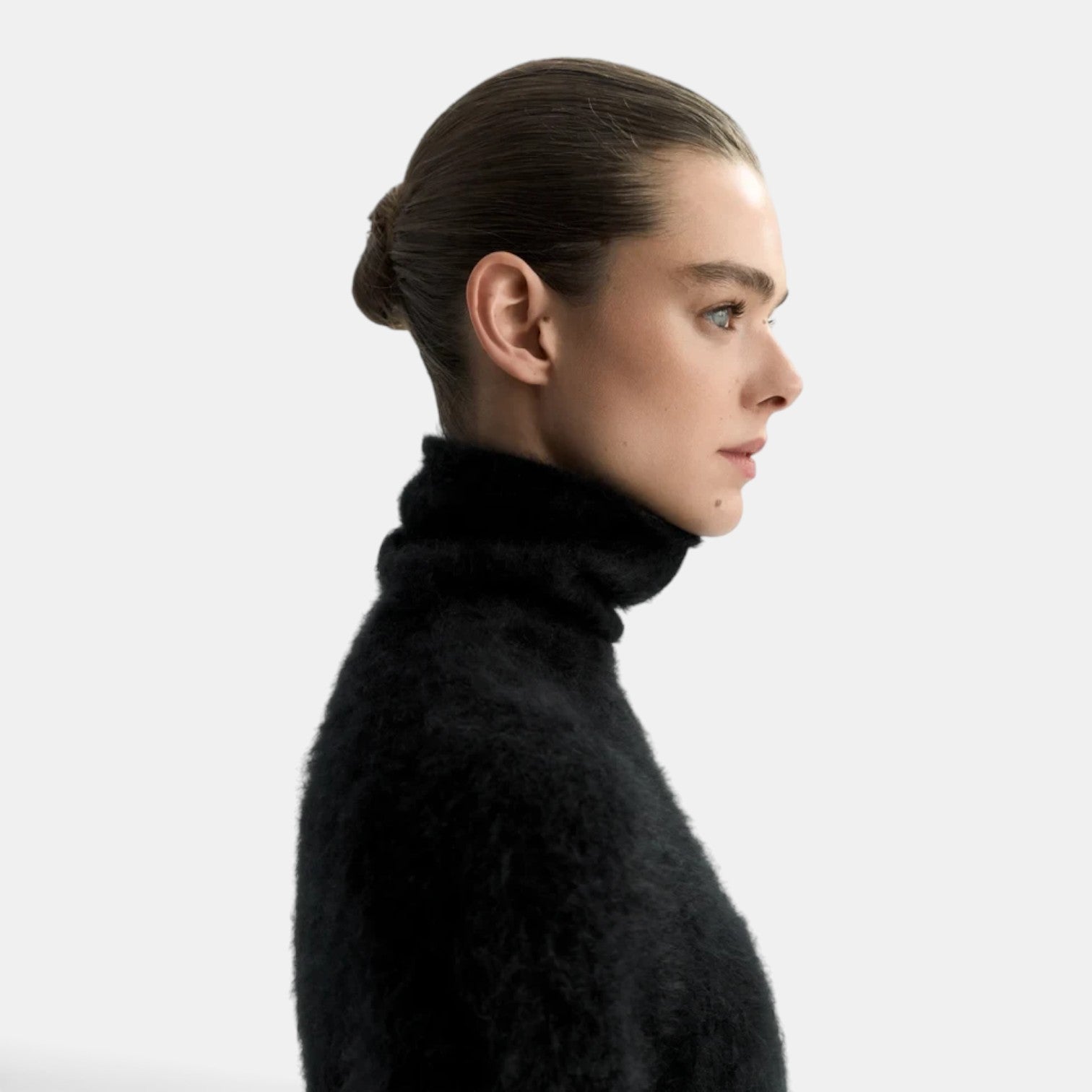 Shop Rescue Spa black brushed cashmere turtleneck sweater worn by a model in profile view