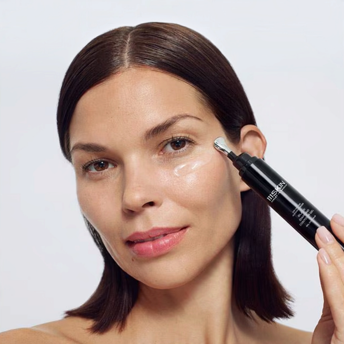 Shop Rescue Spa Black Diamond Contour Gel applied under eye by a woman using the precision applicator tip