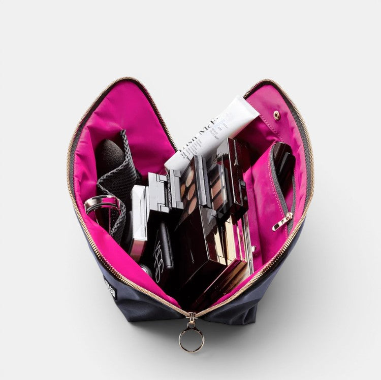 Shop Rescue Spa black leather makeup bag with hot pink interior, open to reveal makeup products and organizer.