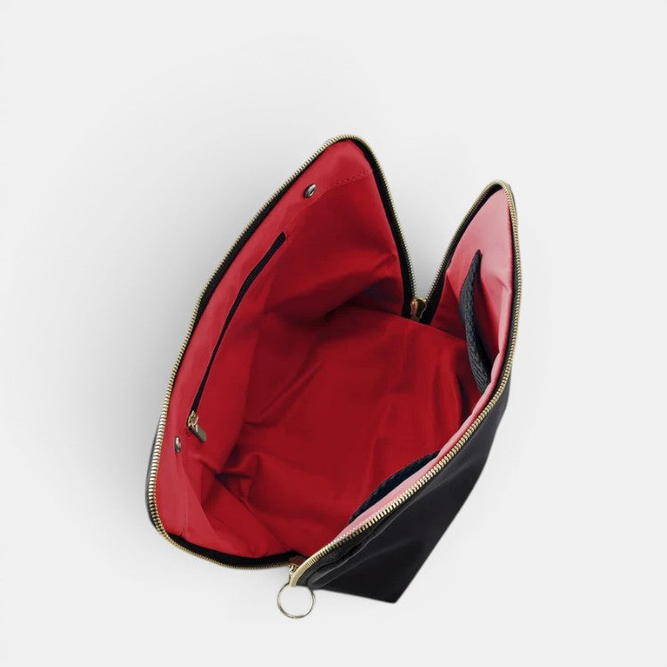 Shop Rescue Spa black leather makeup bag with red interior, gold zipper, and interior zip pocket. Ideal for travel.