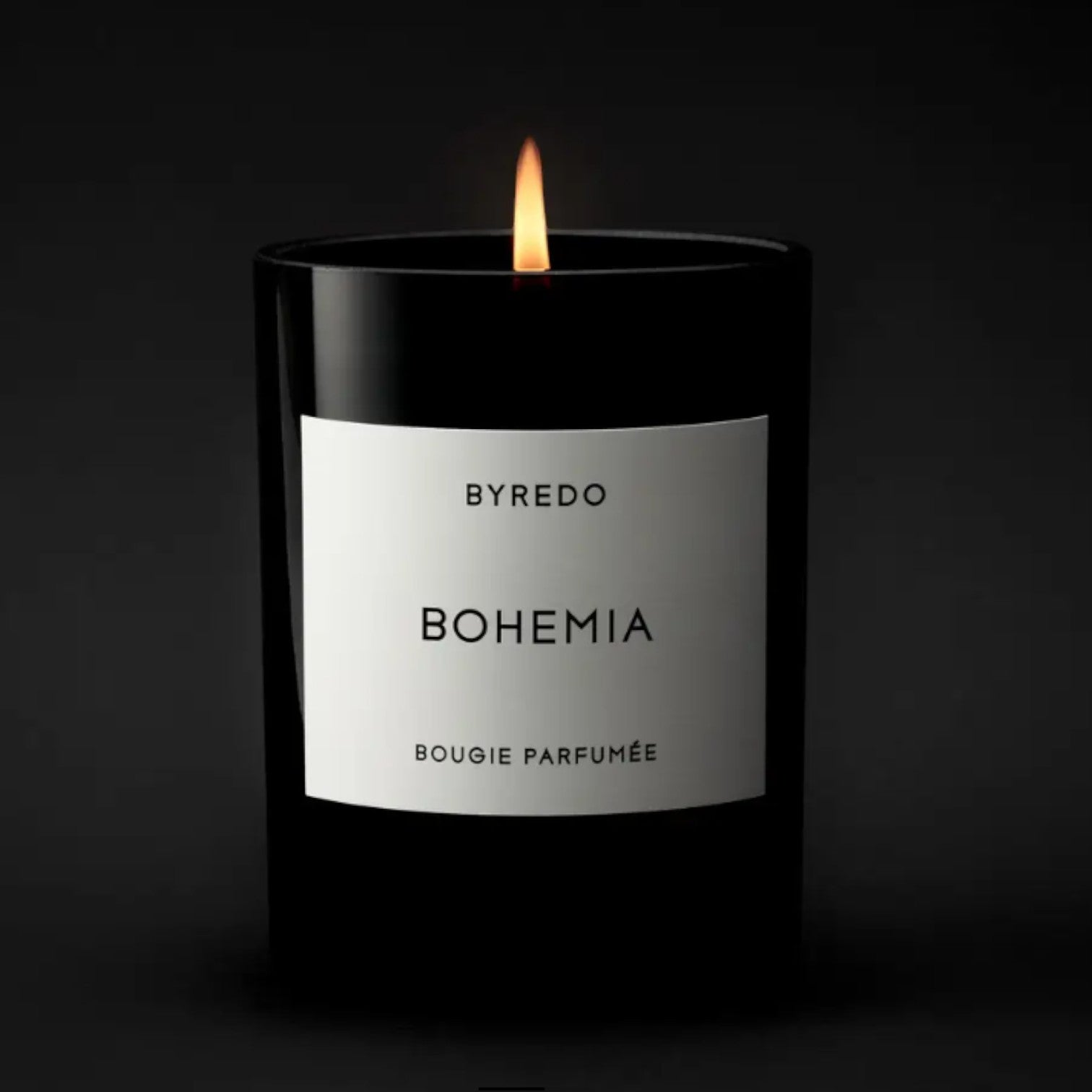 Shop Rescue Spa Bohemia scented candle in a black glass jar with a white label, burning with a warm flame.