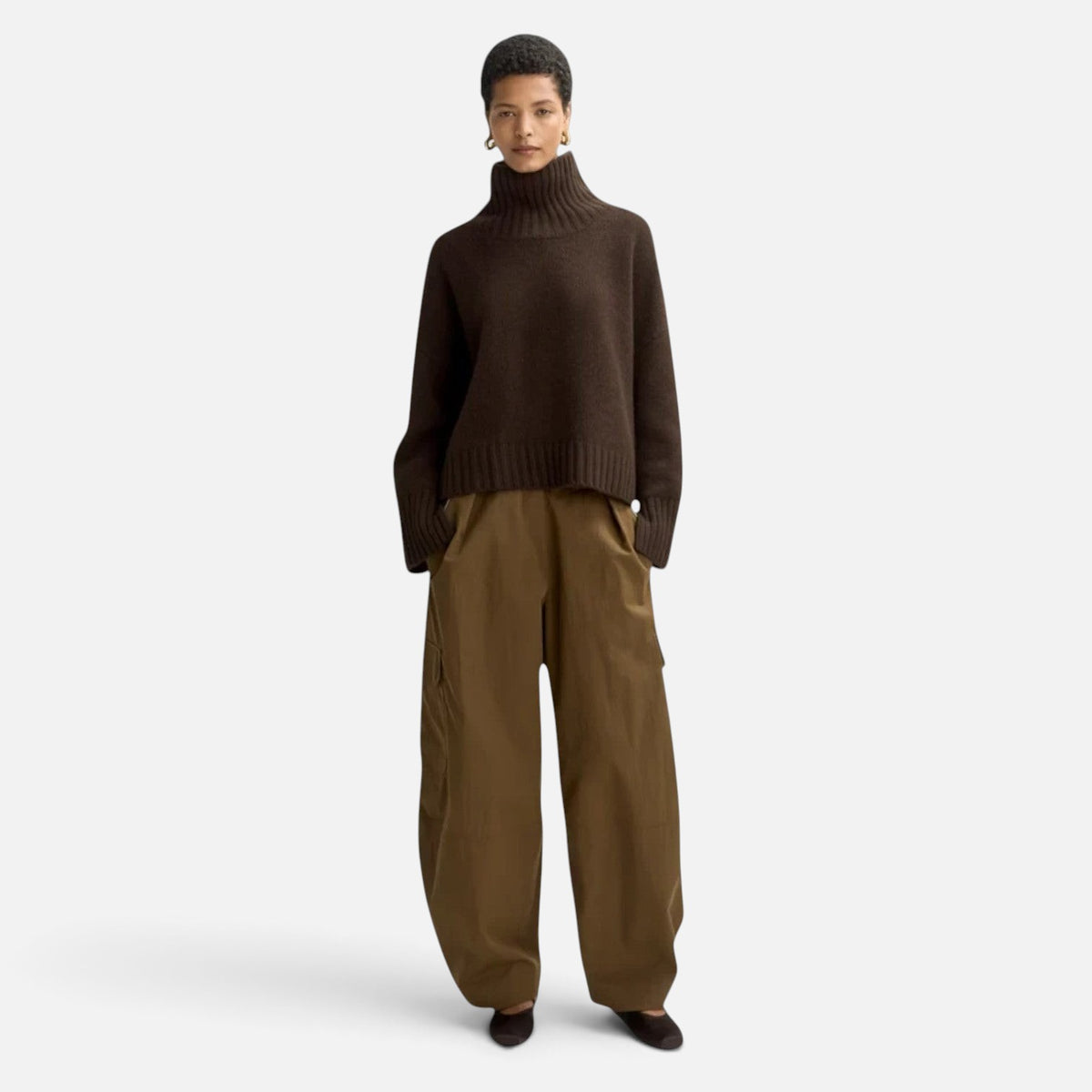 Shop Rescue Spa Girlfriend turtleneck in dark brown chunky cashmere with sleeve slits worn by a model