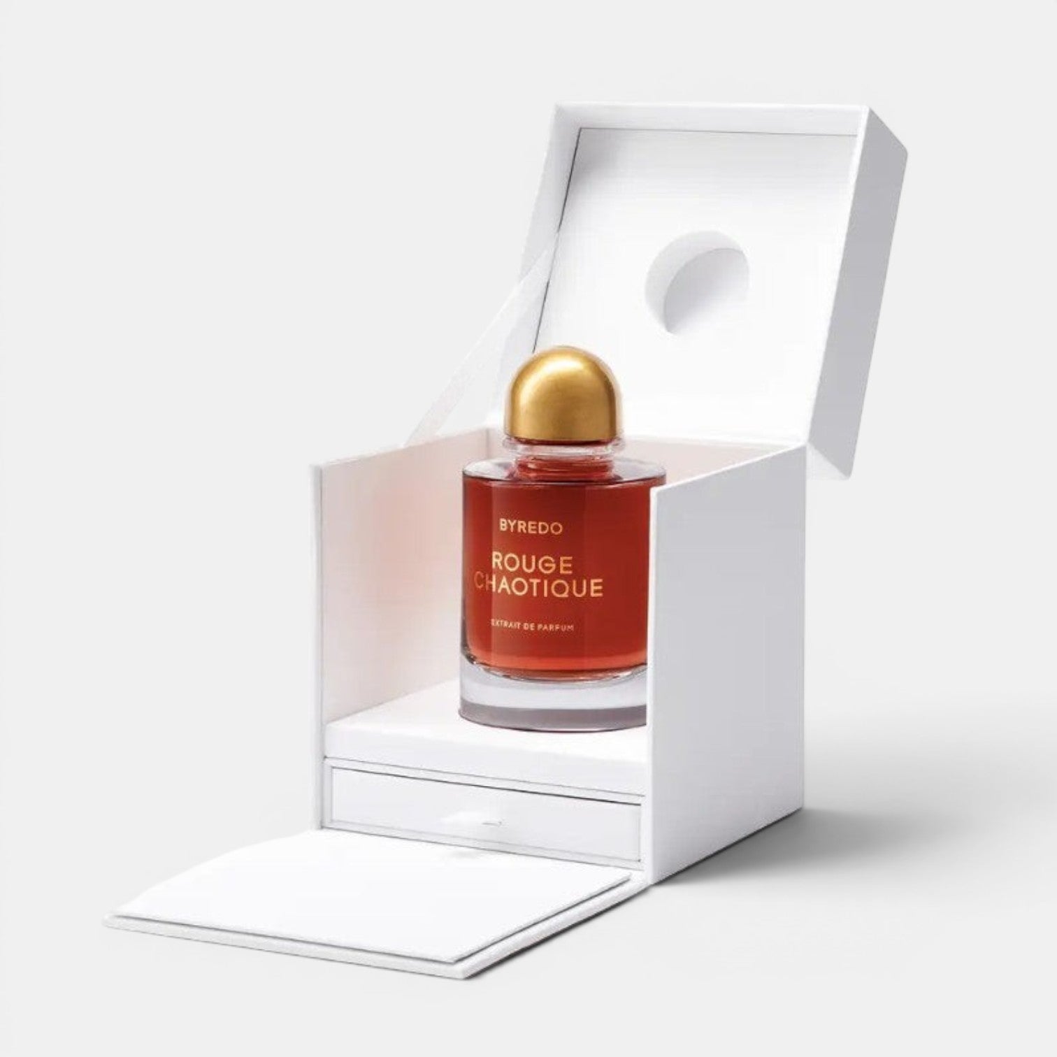 Shop Rescue Spa BYREDO Rouge Chaotique Extrait De Parfum in a red glass bottle with a gold cap, presented in a white box.