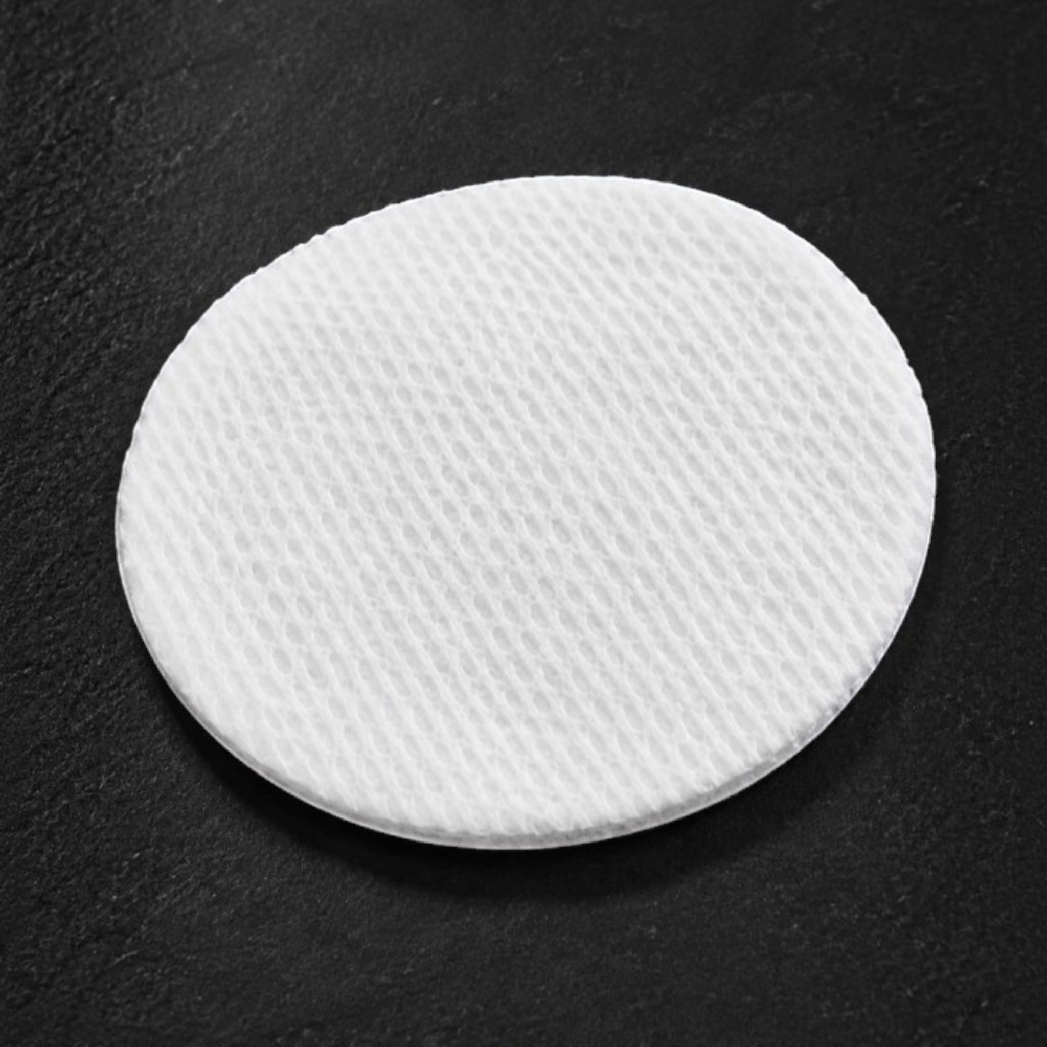Shop Rescue Spa premium white cotton round with a textured exfoliating surface on a dark background