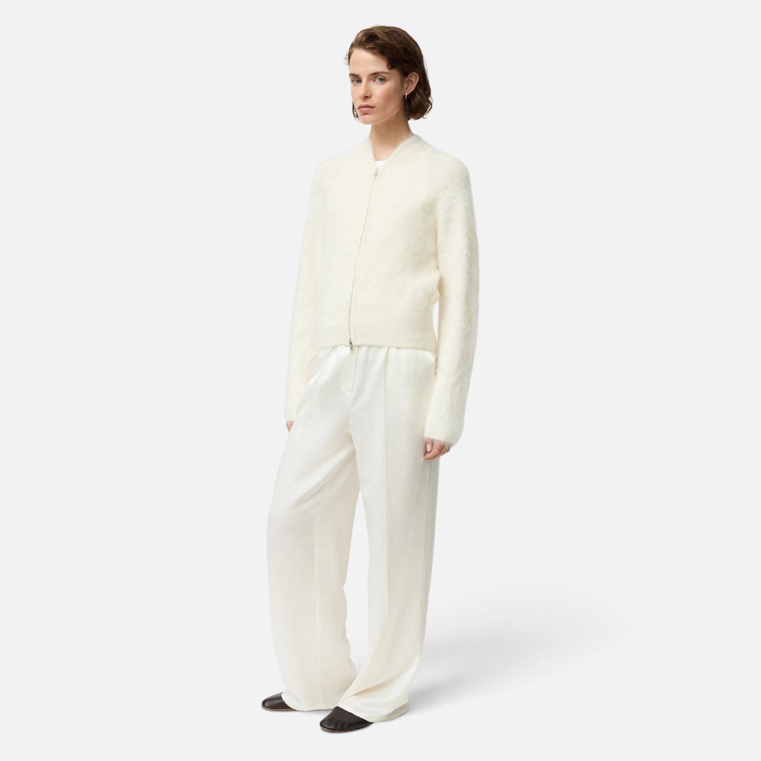 Shop Rescue Spa cream alpaca blend zip cardigan worn by a model with matching white trousers