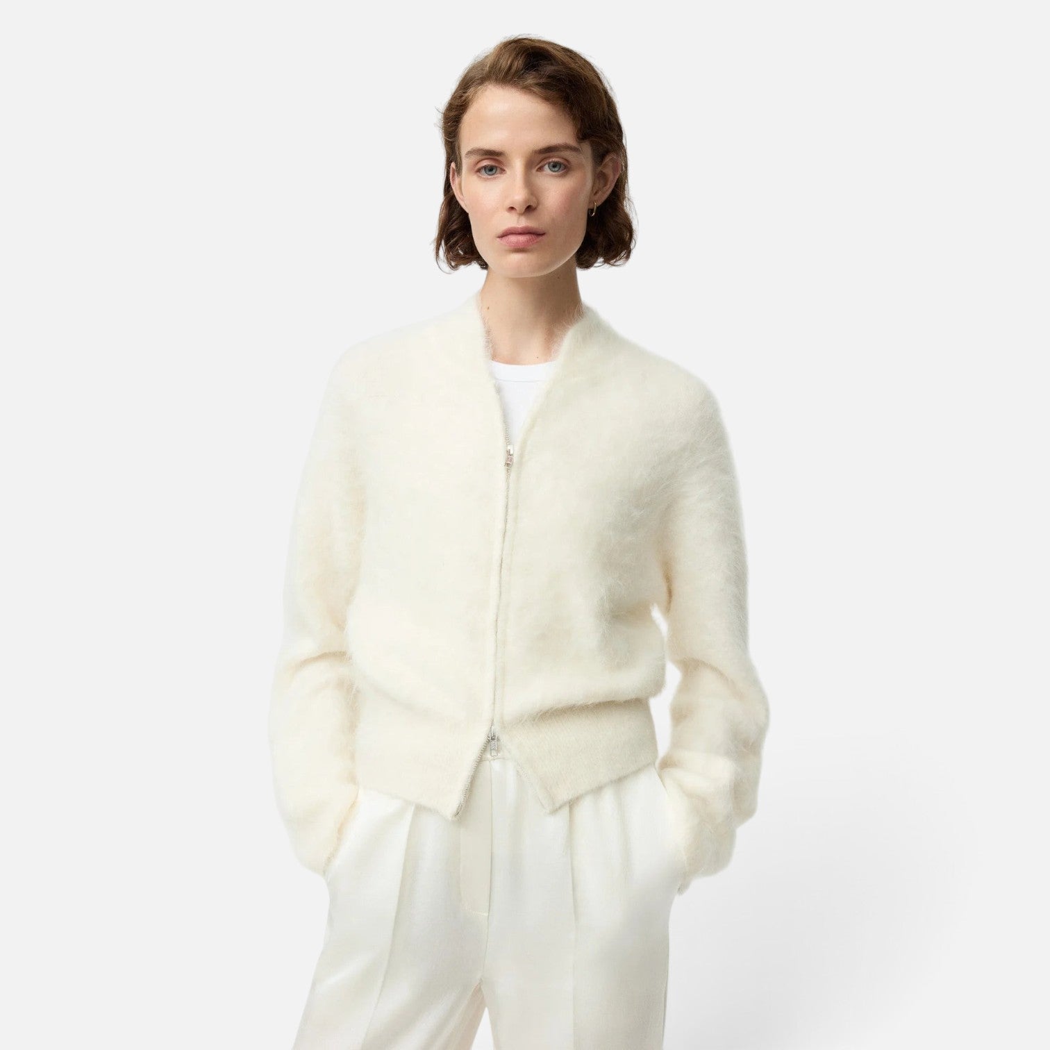 Shop Rescue Spa cream alpaca blend zip-up cardigan worn by a model in a slim fit style.