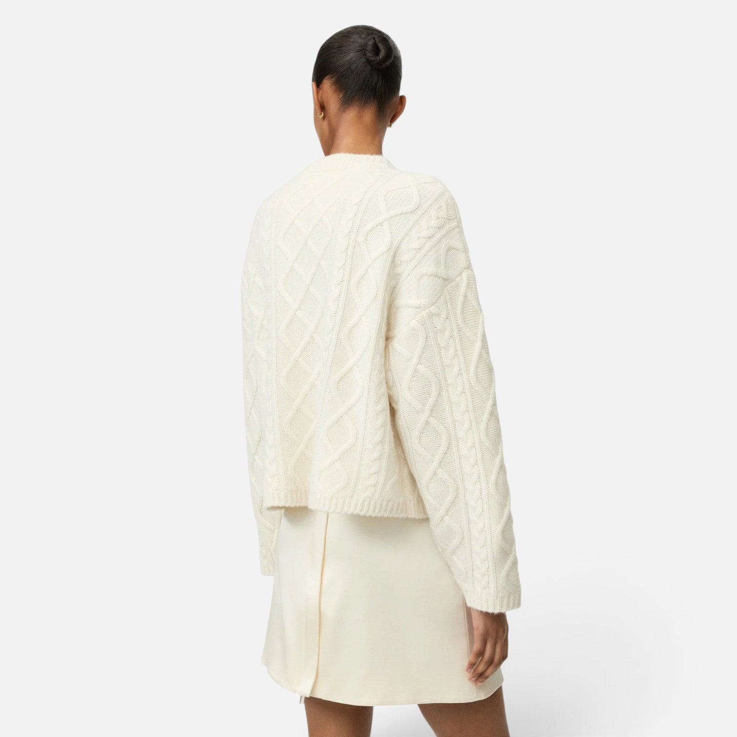 Shop Rescue Spa cream cable knit cashmere cardigan worn by a model, back view showing relaxed fit