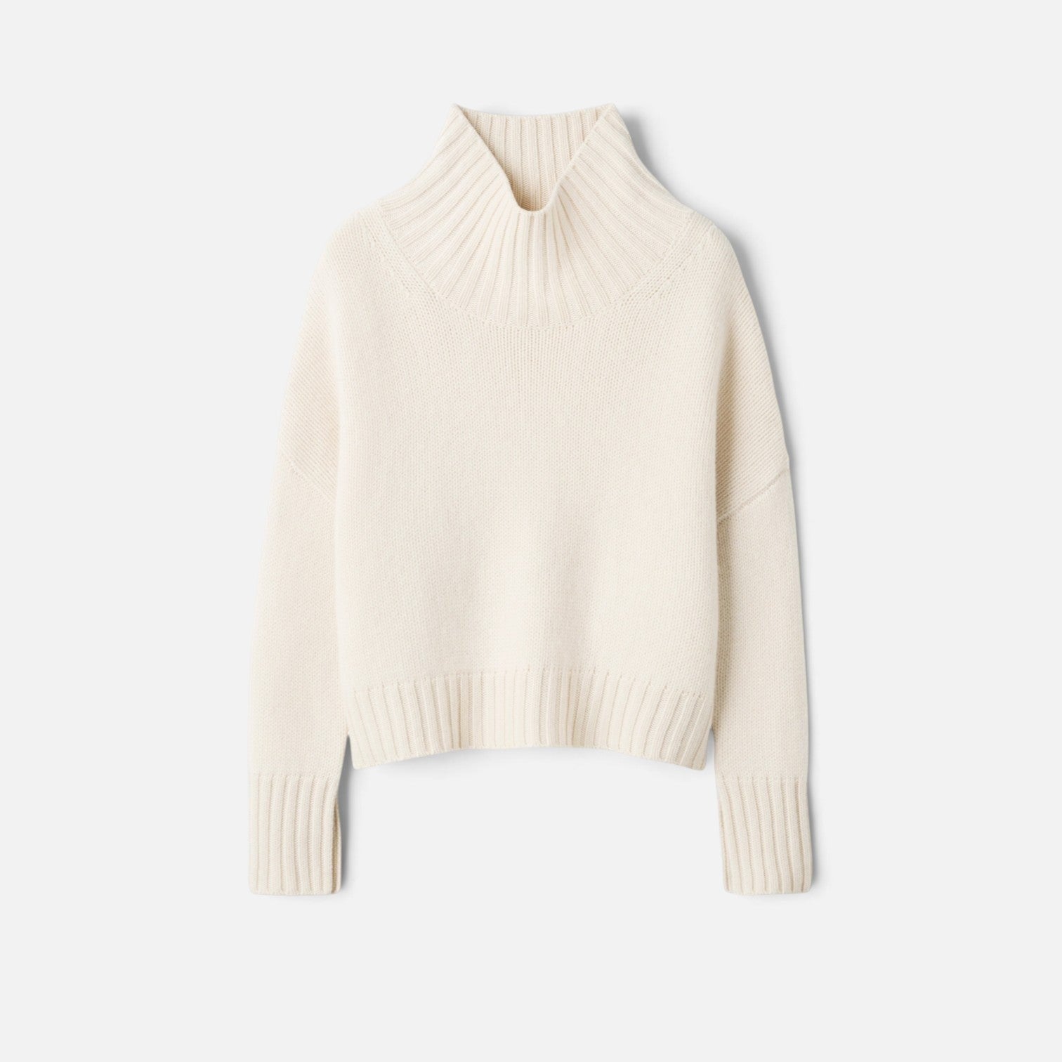 Shop Rescue Spa Girlfriend Turtleneck in cream 100% cashmere with a chunky knit and sleeve slits.