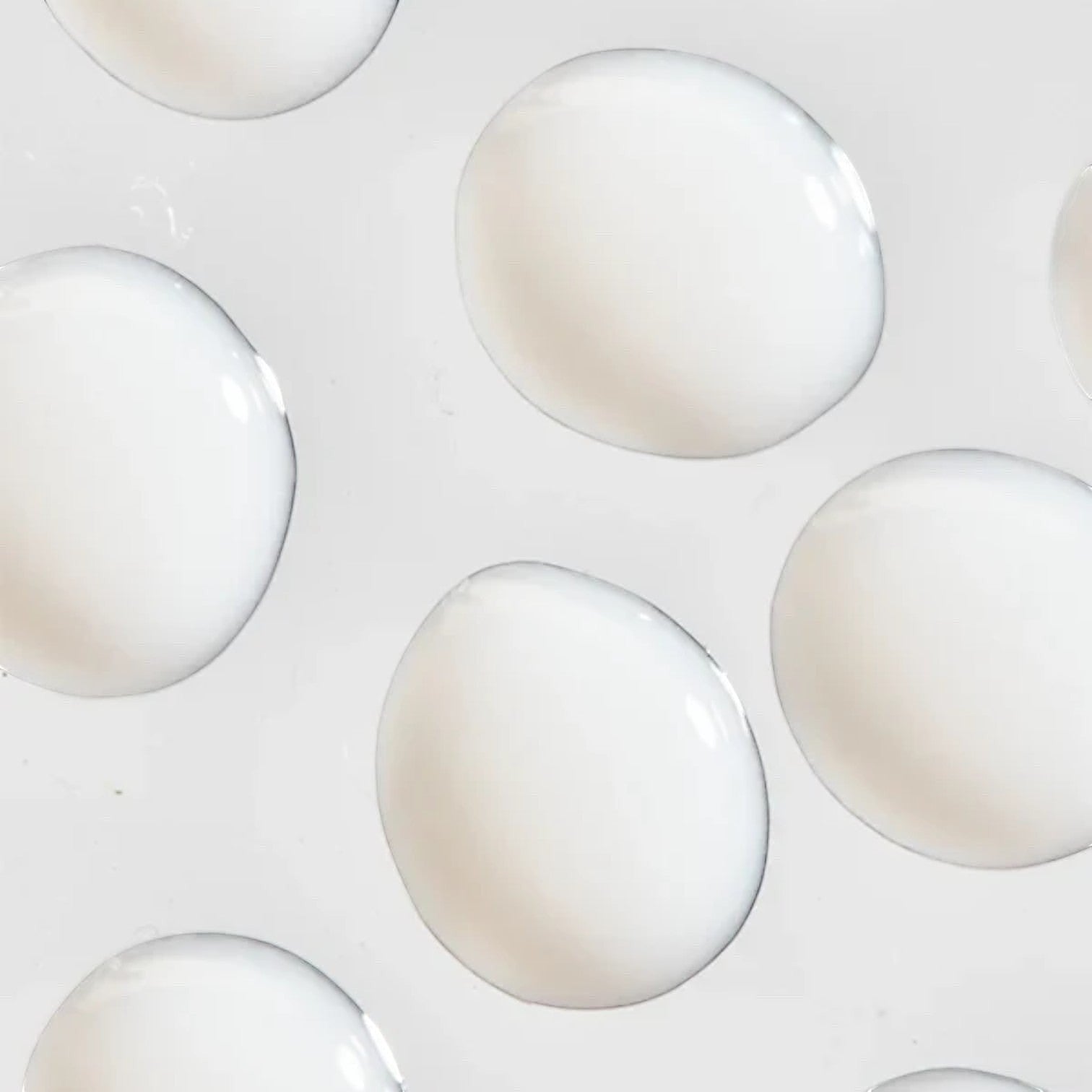 Shop Rescue Spa Cream Supreme moisturizer texture showing smooth white cream droplets on a clean background