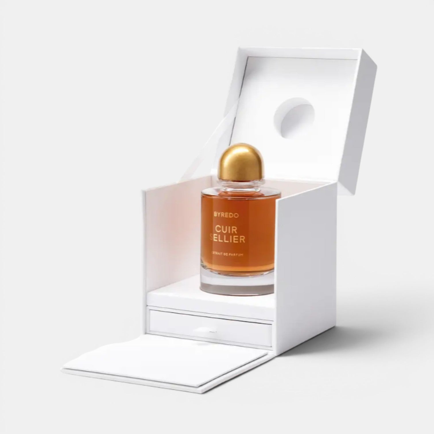 Shop Rescue Spa Byredo Cuir Sellier Extrait De Parfum amber glass bottle with gold cap in white box. Notes of leather, tobacco, oakmoss.