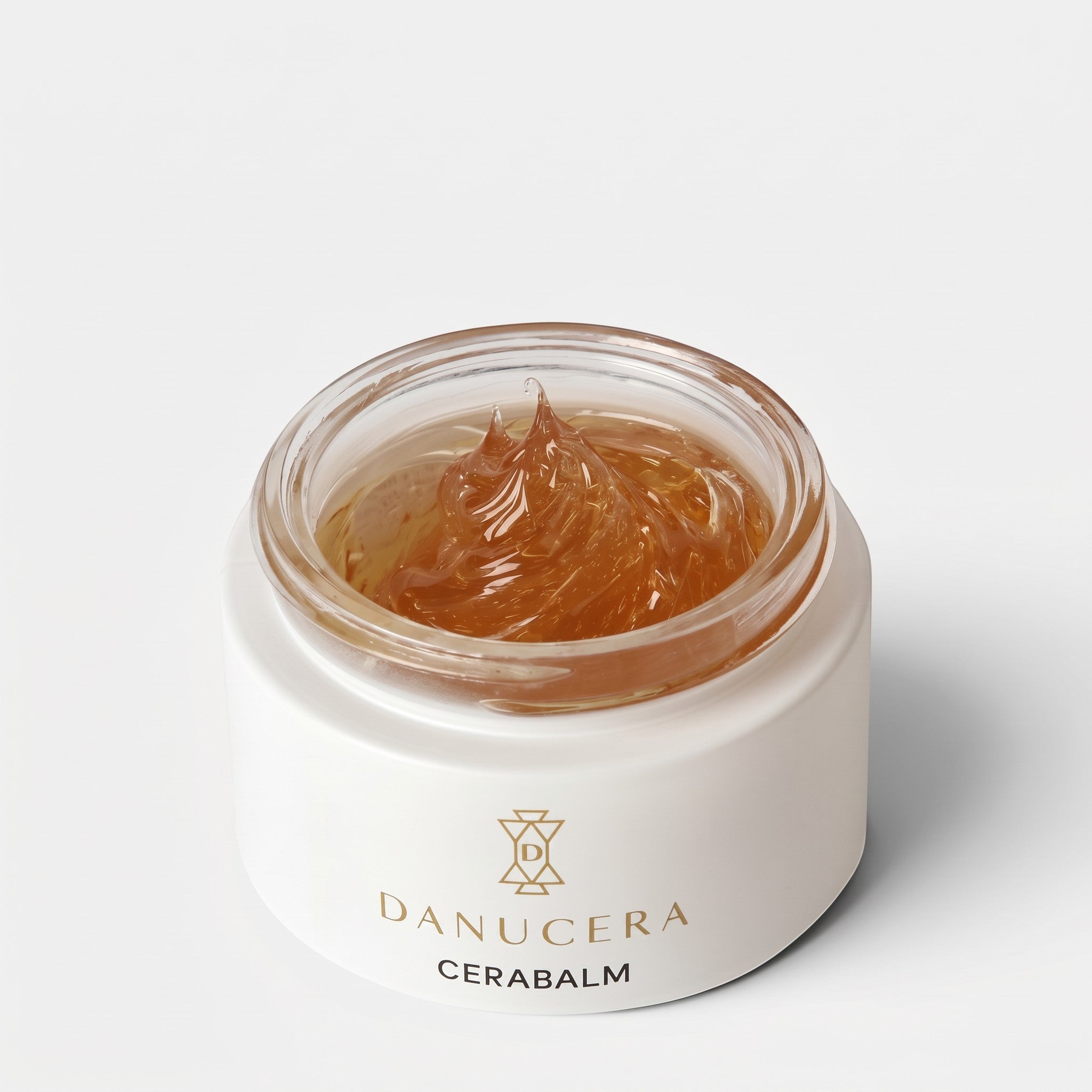 Shop Rescue Spa Danucera Cerabalm multi-purpose cleansing balm in a white jar with a rich amber-coloured texture.