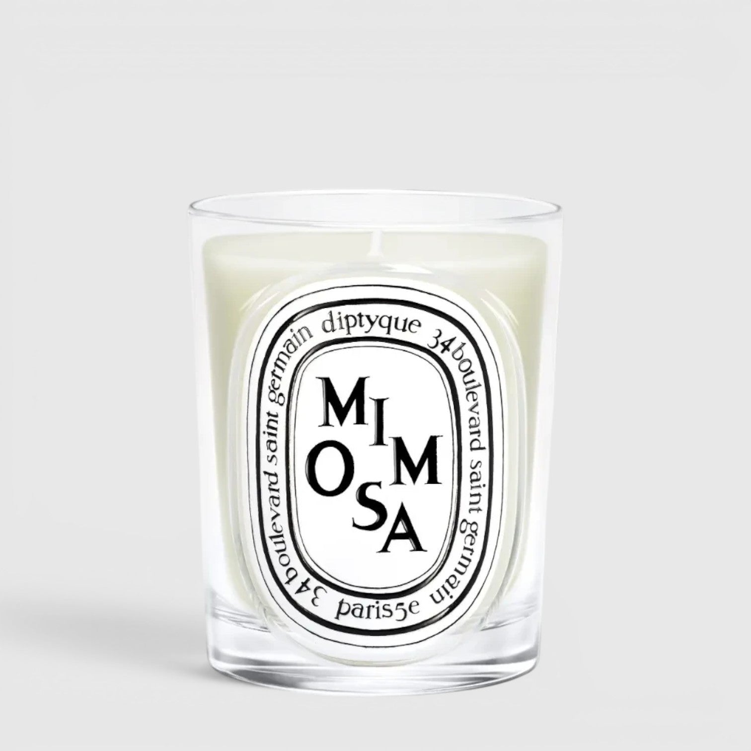Shop Rescue Spa Diptyque Mimosa scented candle in a clear glass vessel with a signature oval label