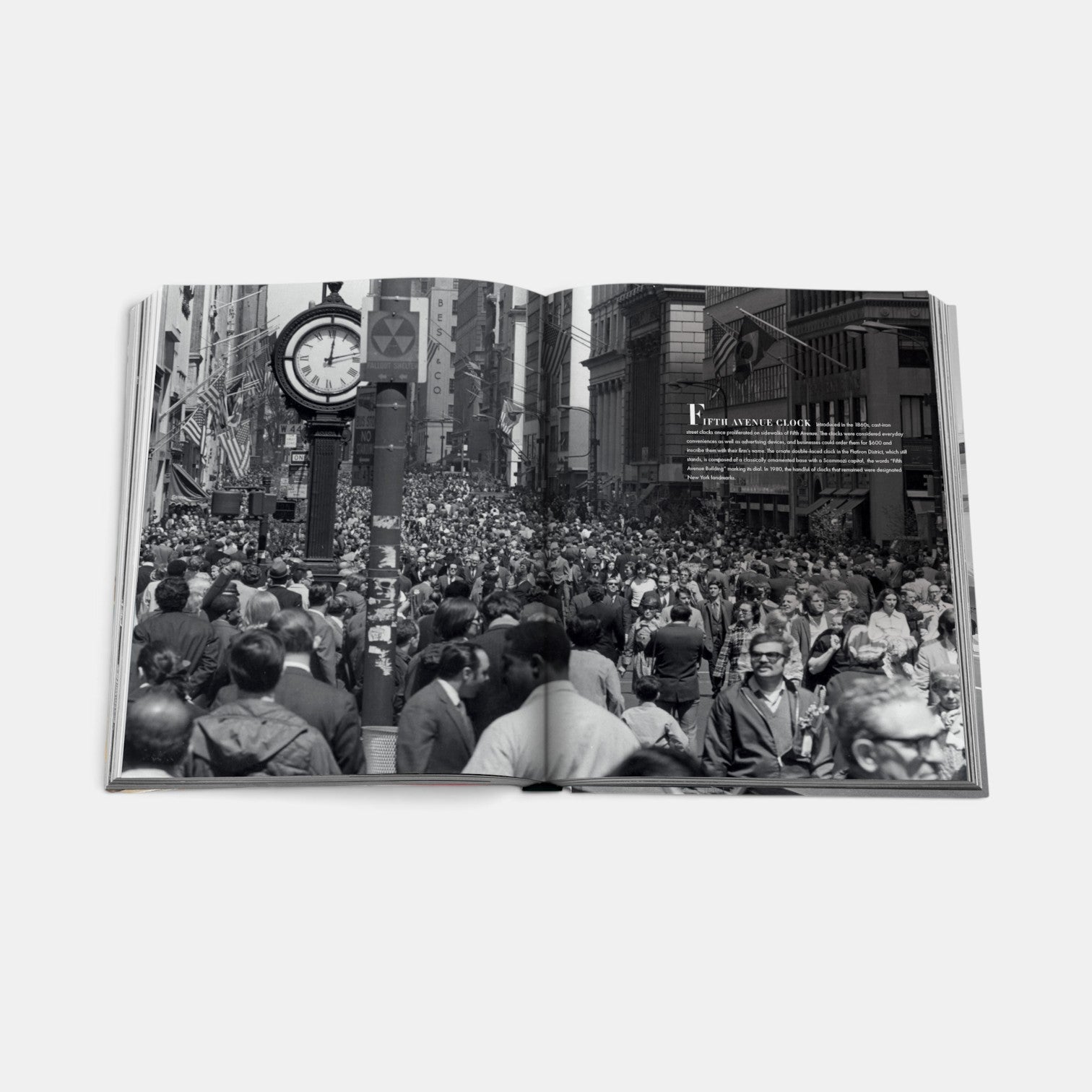 Shop Rescue Spa Fifth Avenue book open to a black and white photograph of a crowded street scene with a vintage clock.
