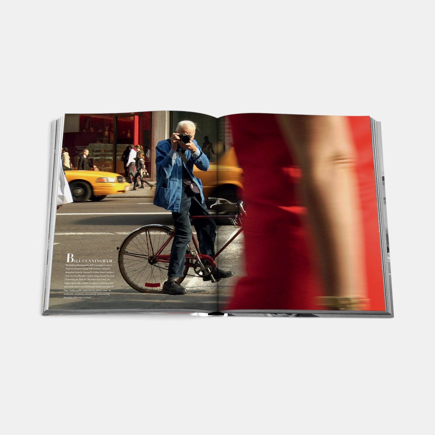 Shop Rescue Spa Fifth Avenue book open to a page featuring Bill Cunningham on a bicycle in New York City
