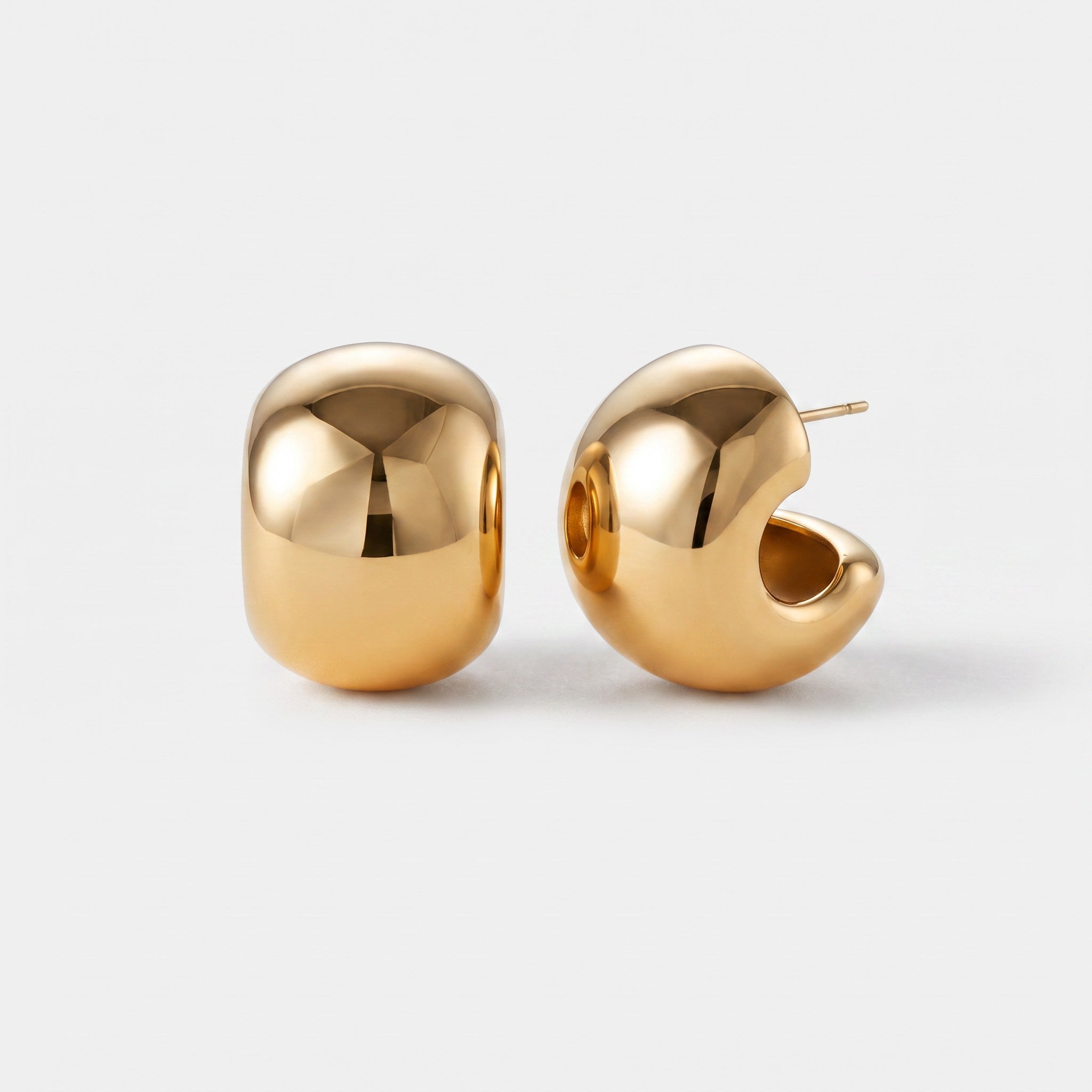 Shop Rescue Spa Gemma chunky gold hoop earrings with a high-polish finish and hollowed-out sculptural design.