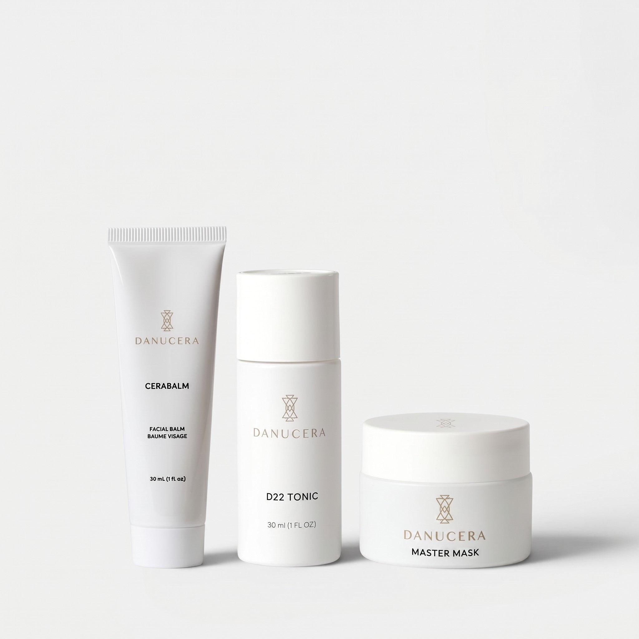 Shop Rescue Spa The Glow Trio skincare set featuring Danucera Cerabalm, D22 Tonic, and Master Mask in white bottles.