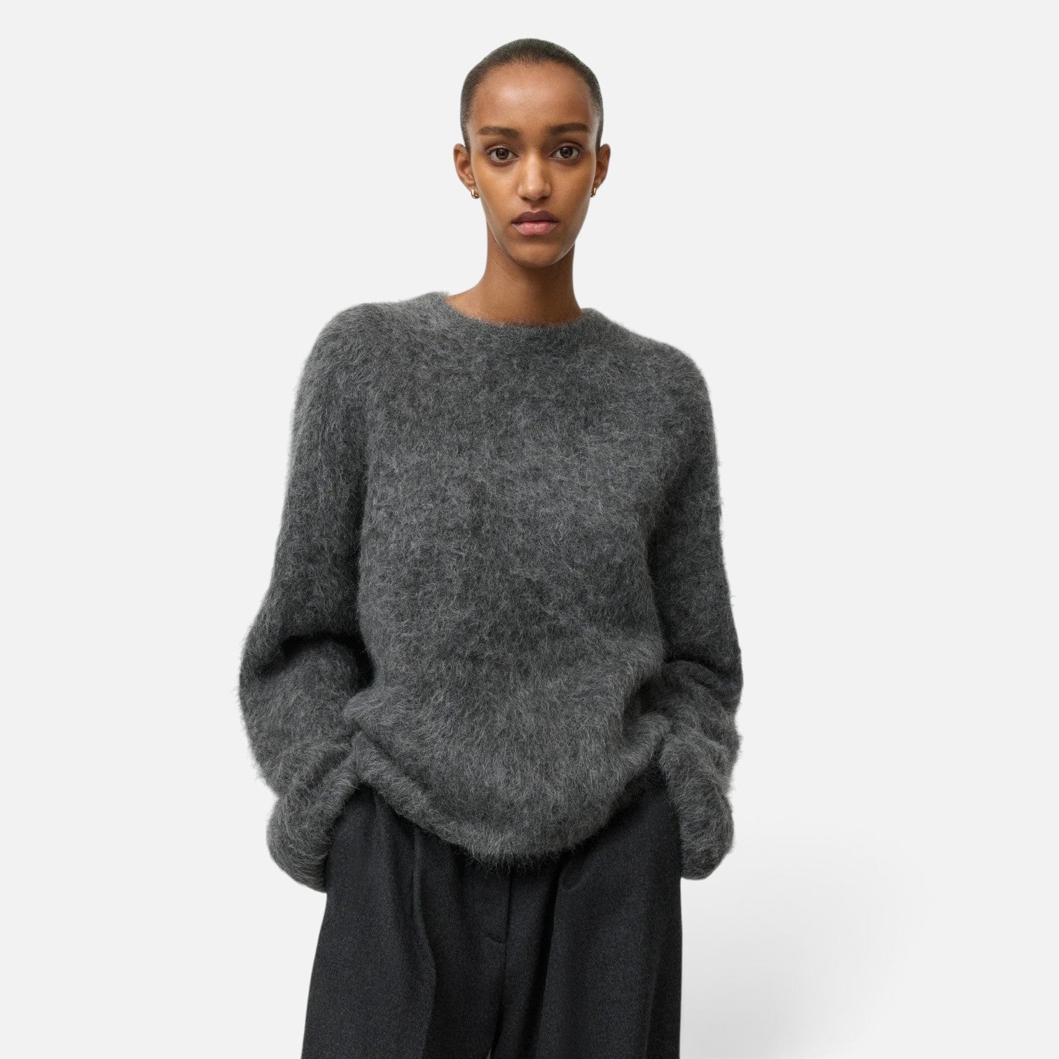 Shop Rescue Spa grey alpaca blend crewneck sweater with a relaxed fit worn by a model