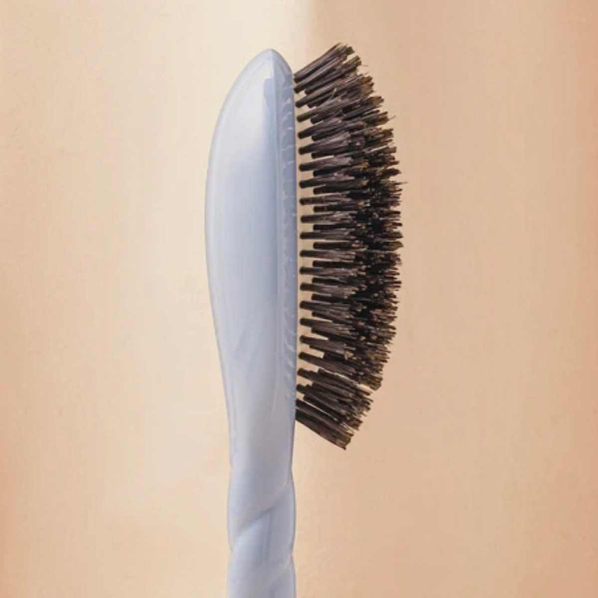 Shop Rescue Spa N.01 large hair brush with ivory handle and dark boar bristles in a side profile view