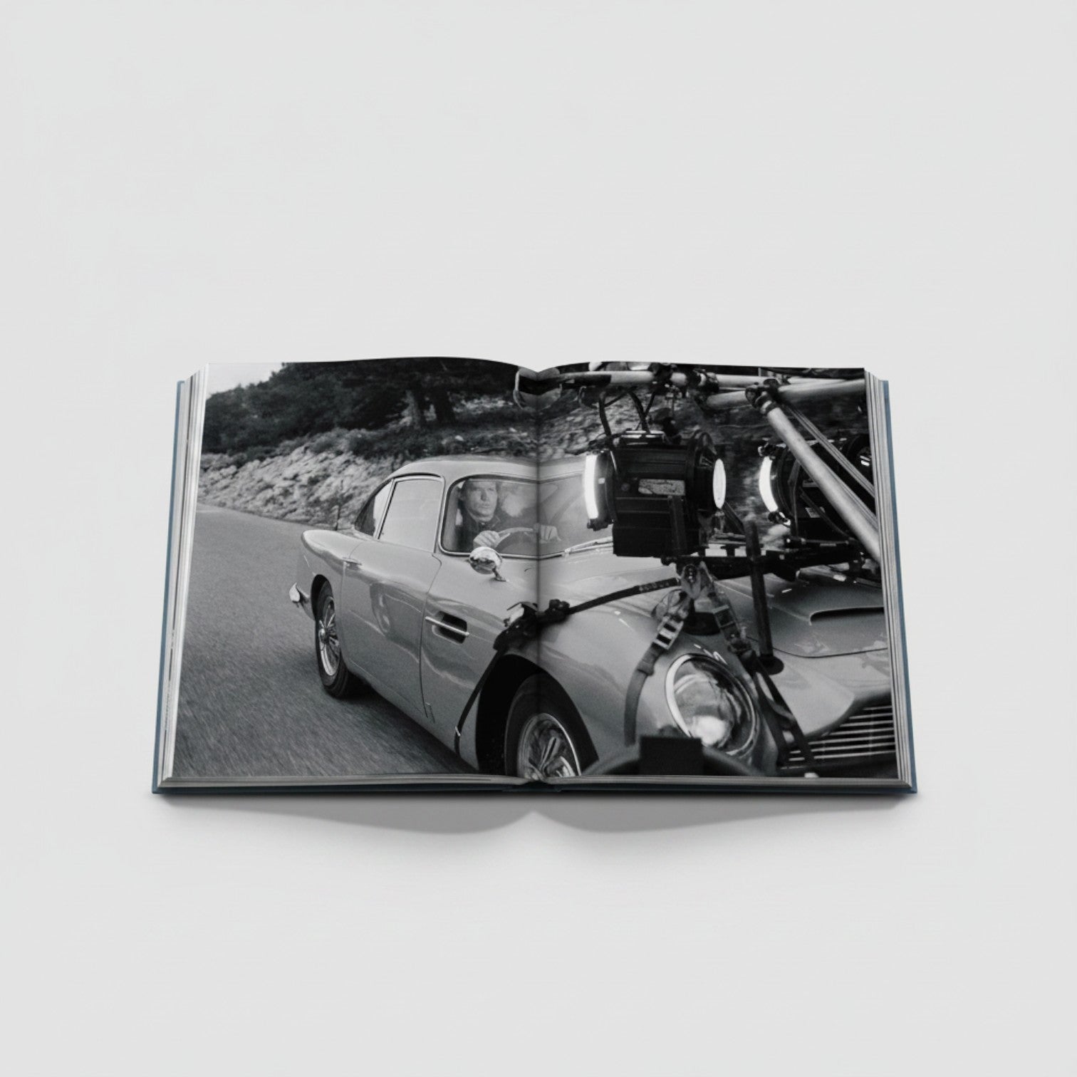 James Bond Cars book featuring an Aston Martin DB5 on set with filming equipment attached.