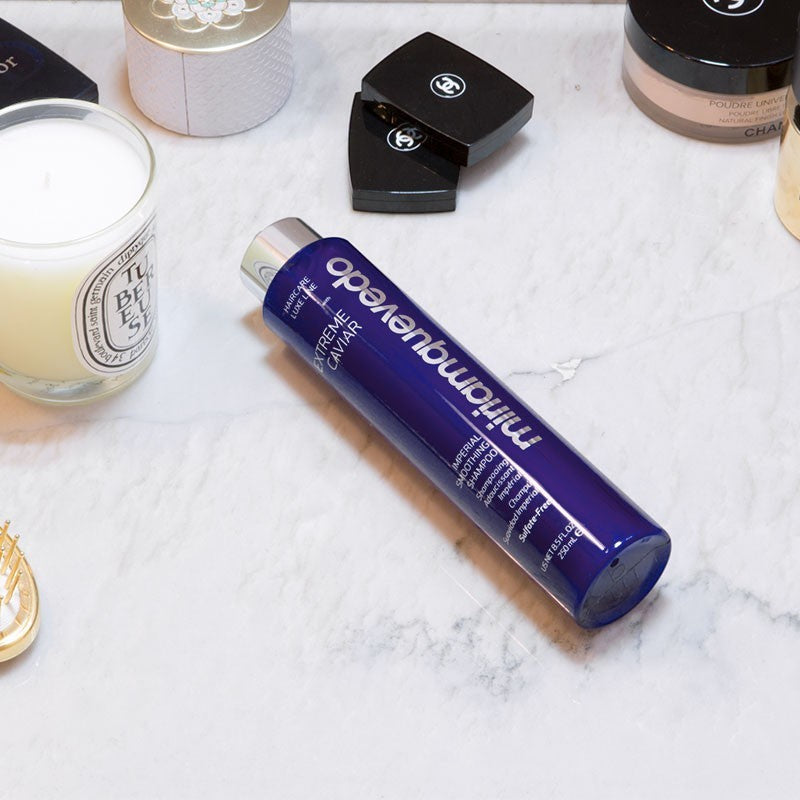 Shop Rescue Spa Miriam Quevedo Extreme Caviar Imperial Smoothing Shampoo in a dark blue bottle on a marble surface.
