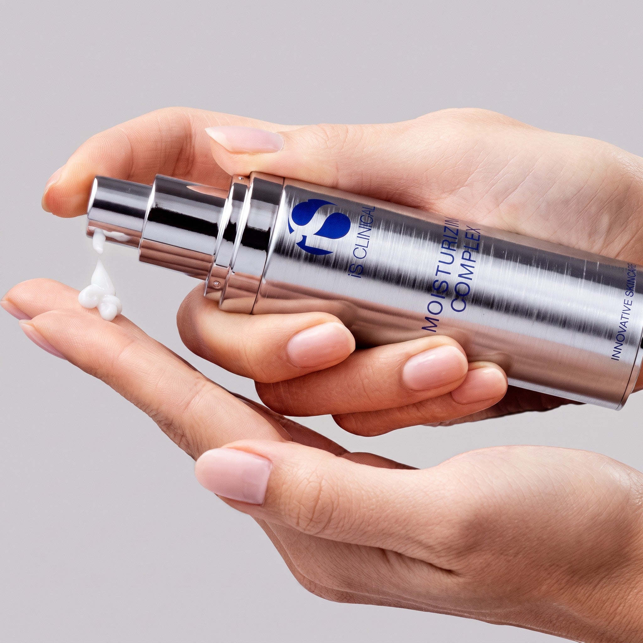 Shop Rescue Spa iS Clinical Moisturizing Complex cream being dispensed onto a hand for hydrating skincare application