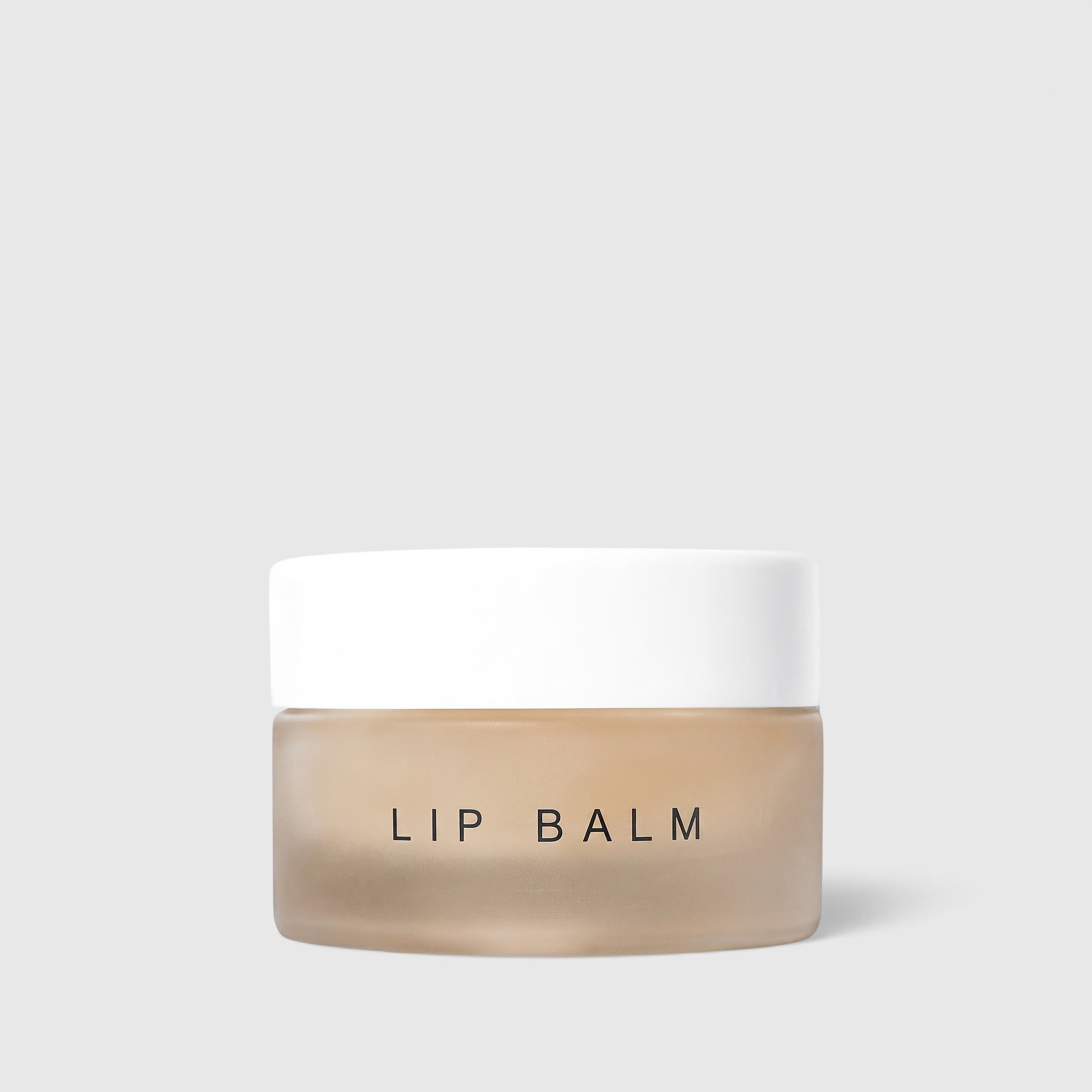 Shop Rescue Spa nourishing lip balm in a small frosted glass jar with a white lid for dry and cracked lips