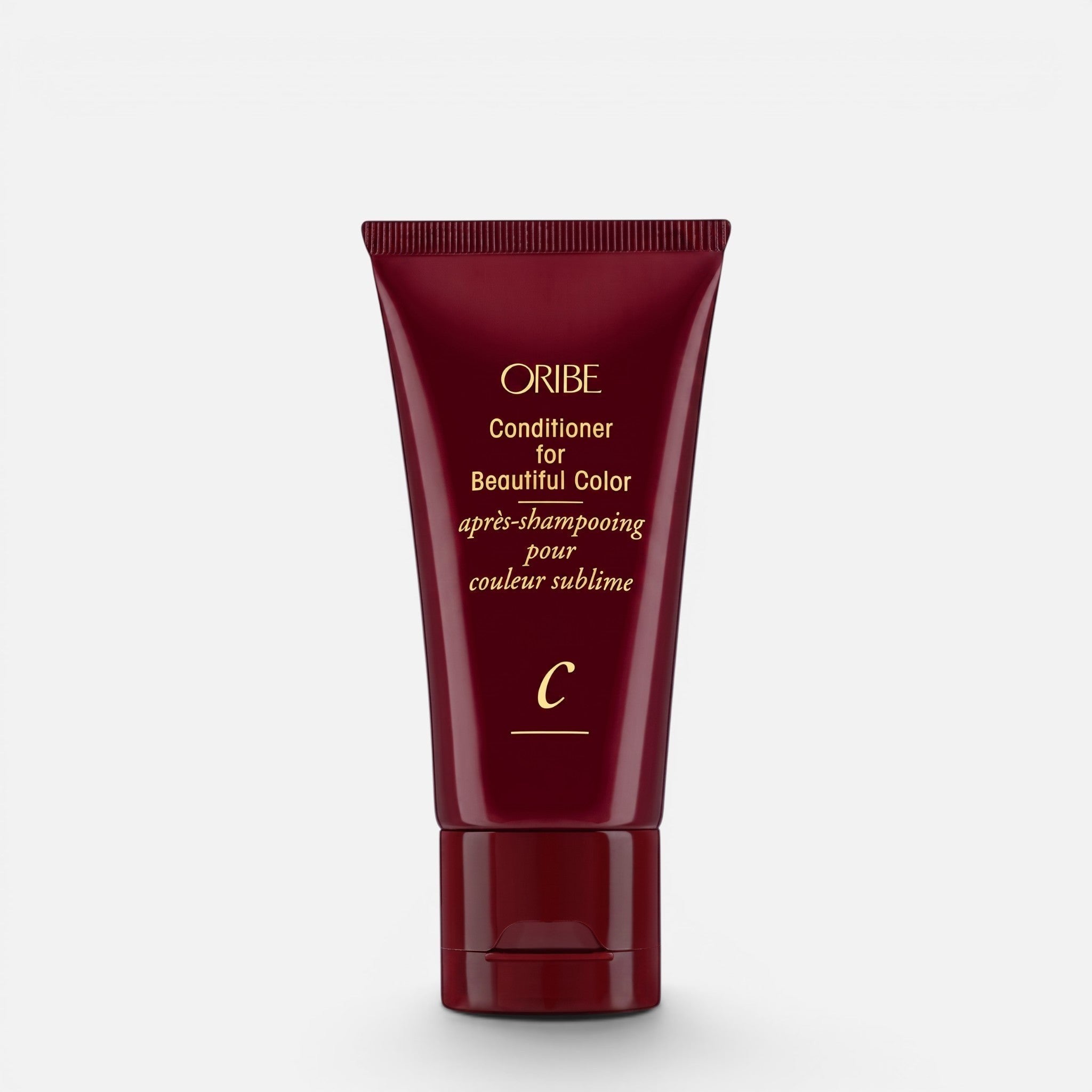 Shop Rescue Spa Oribe Conditioner for Beautiful Color in a deep red squeeze tube for color-treated hair