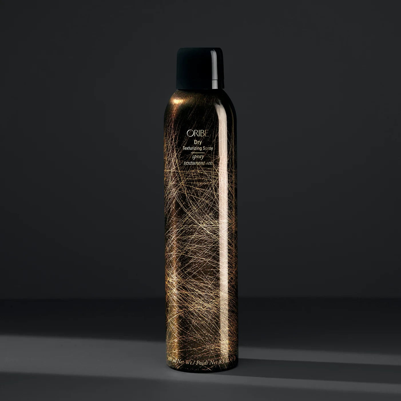 Shop Rescue Spa Oribe Dry Texturizing Spray in a black and gold patterned aerosol bottle for hair volume and texture.