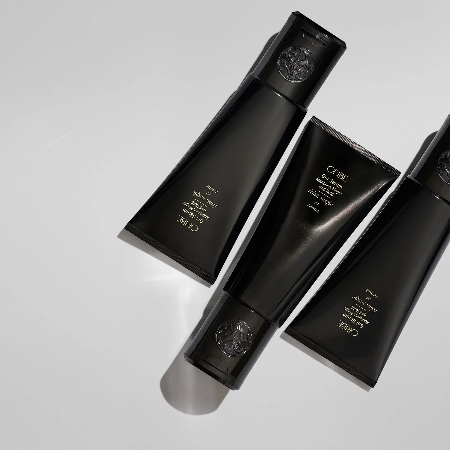 Shop Rescue Spa Oribe Gel Serum with gold flecks for flexible hold and moisture. Black tubes.