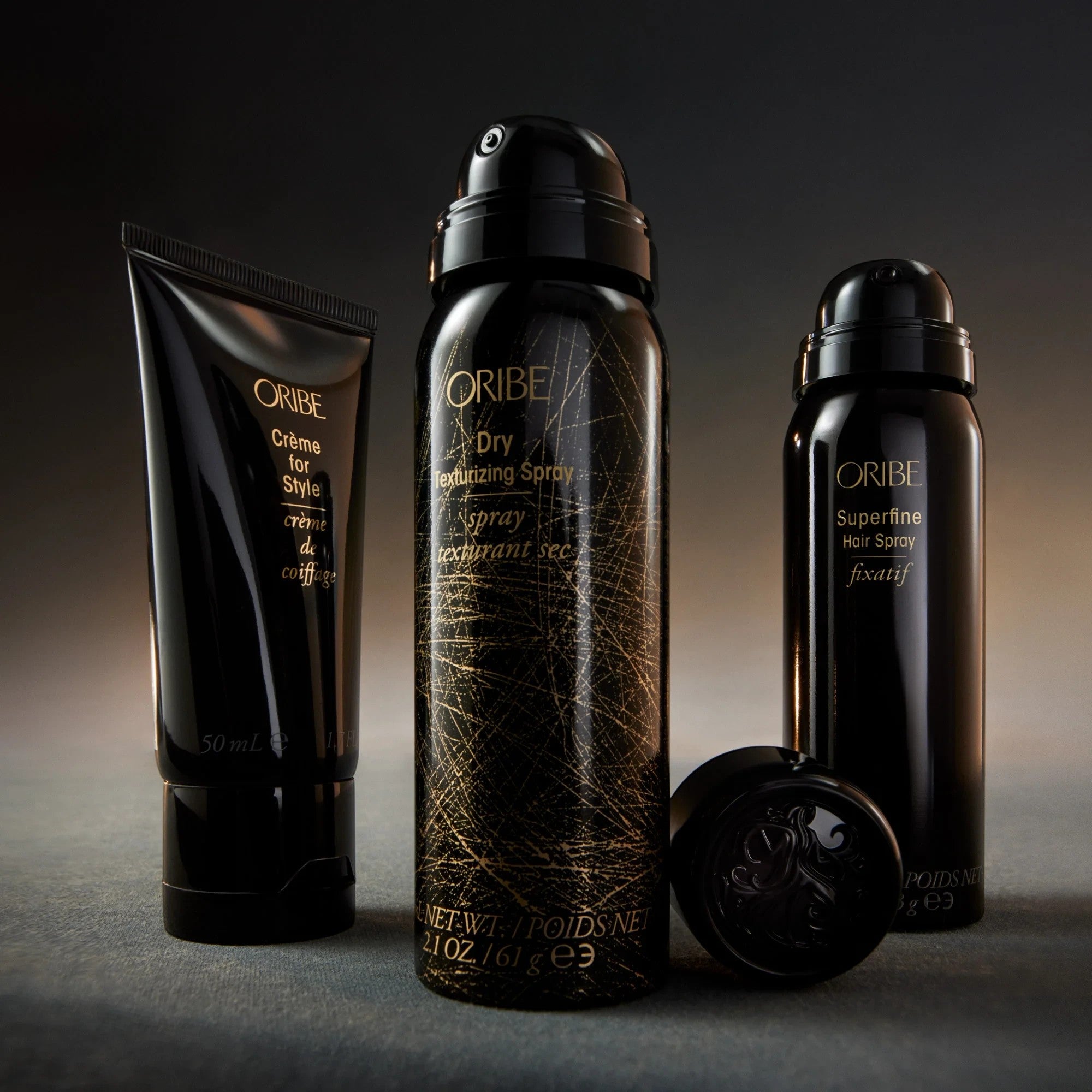 Shop Rescue Spa Oribe Dry Texturizing Spray, Creme for Style, and Superfine Hair Spray in black packaging