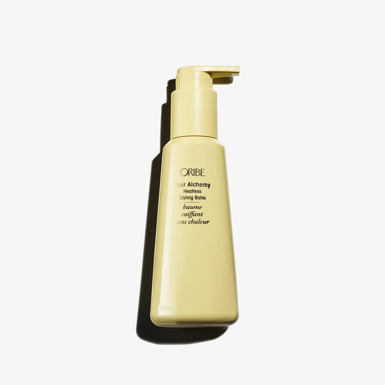 Shop Rescue Spa Oribe Hair Alchemy Heatless Styling Balm in a pale yellow pump bottle for air-dried hair styling.