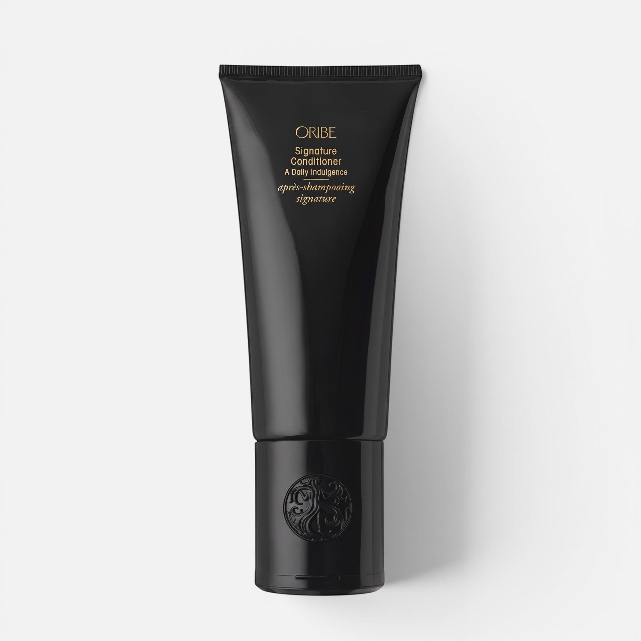 Shop Rescue Spa Oribe Signature Conditioner in a sleek black squeeze tube for restorative hair hydration.