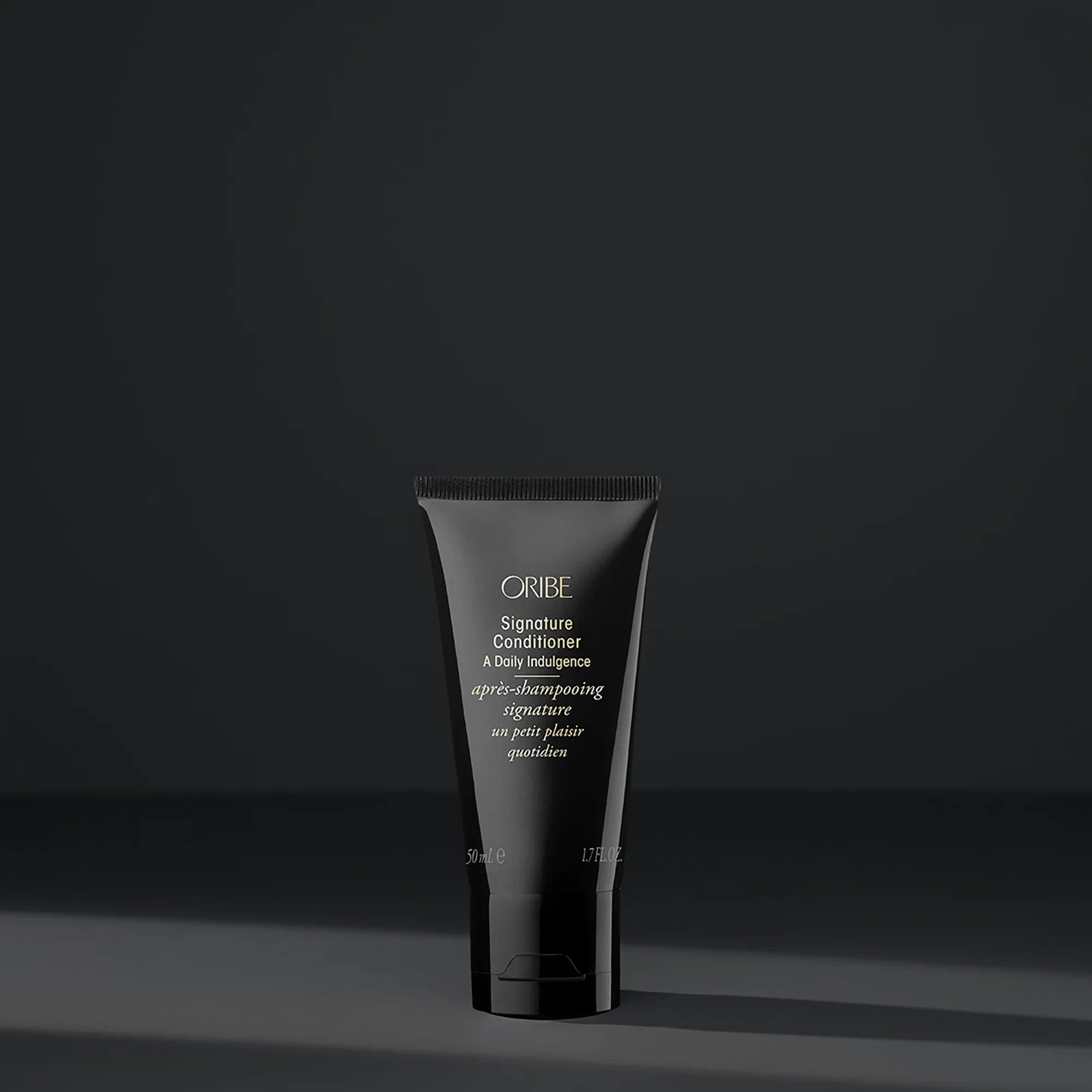 Shop Rescue Spa Oribe Signature Conditioner in a sleek black 50ml travel-size tube for daily hair moisturizing.