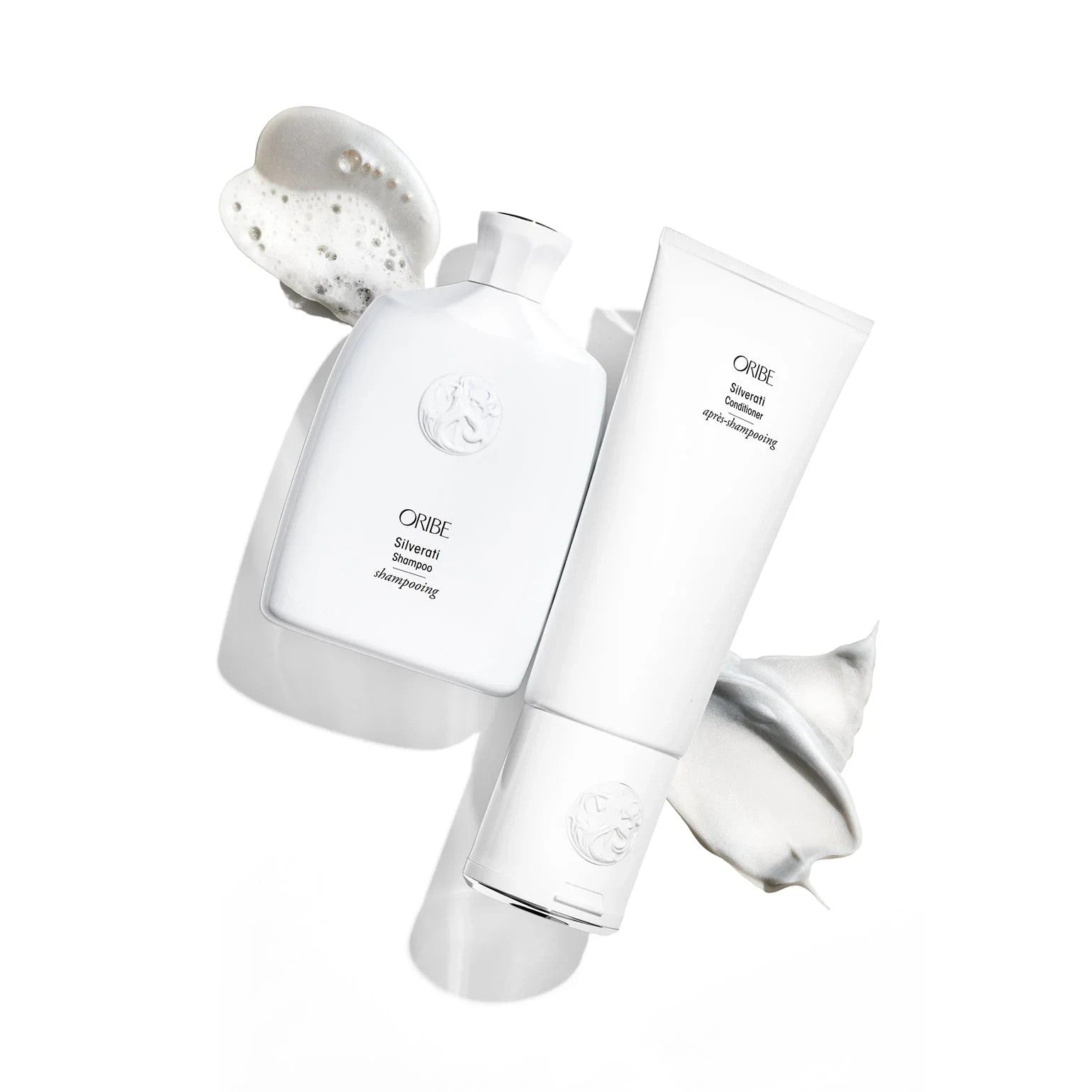 Shop Rescue Spa ORIBE Silverati Conditioner tube with white cream swatch and ORIBE Silverati Shampoo bottle with foam swatch.