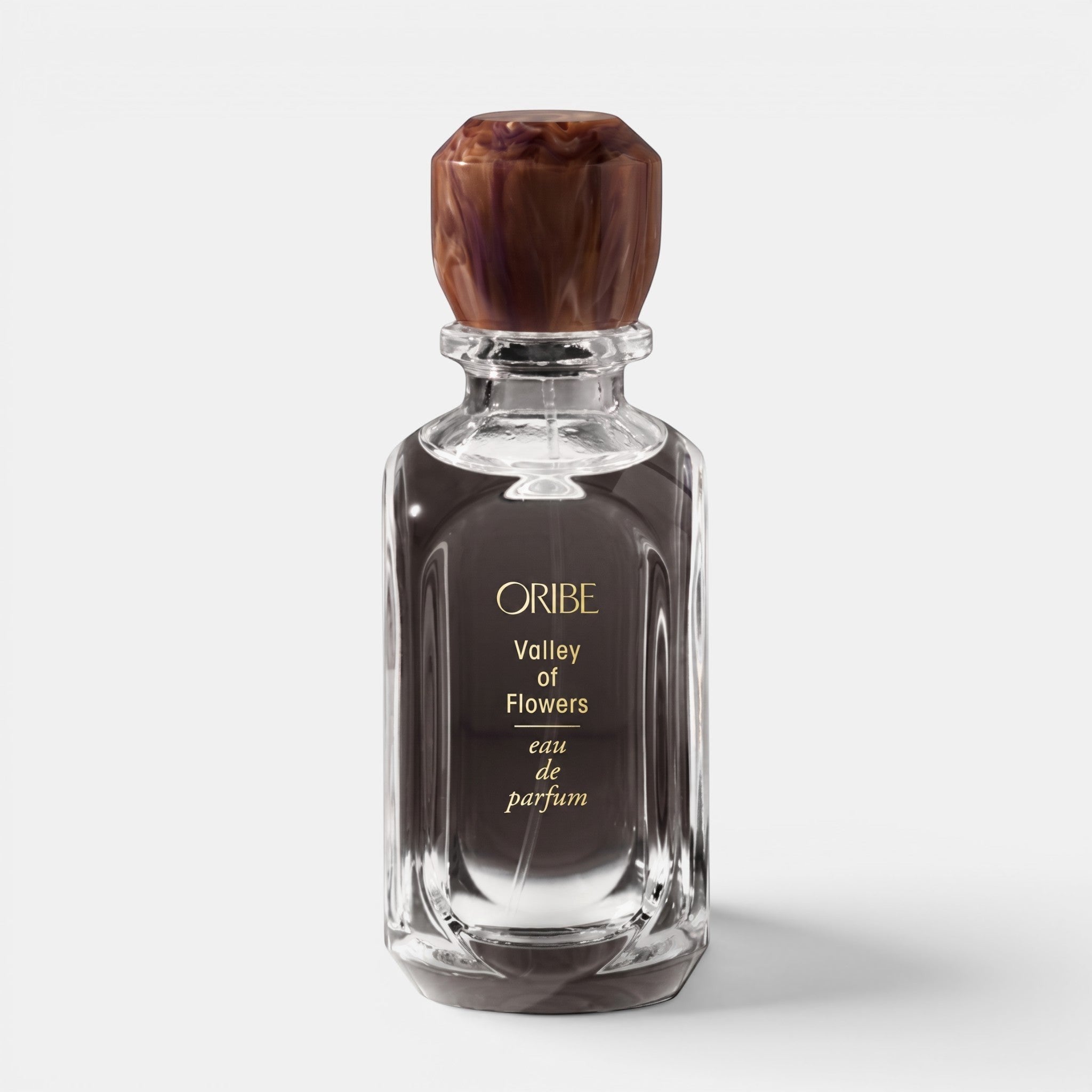 Shop Rescue Spa Oribe Valley of Flowers eau de parfum in a glass bottle with a decorative brown marbled cap.