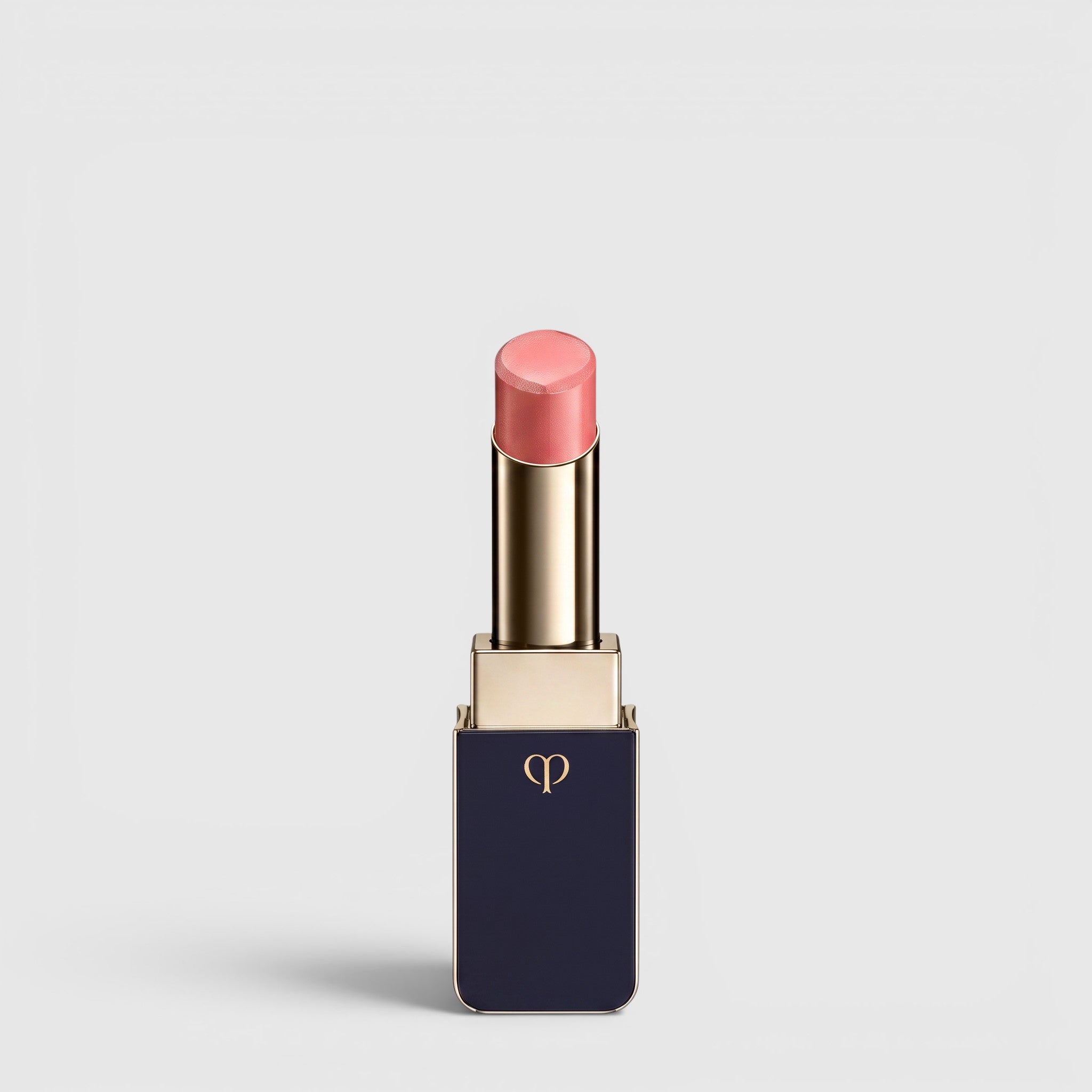 Shop Rescue Spa Lipstick Shine in a soft pink shade with a luminous dewy finish in a sleek navy and gold tube.