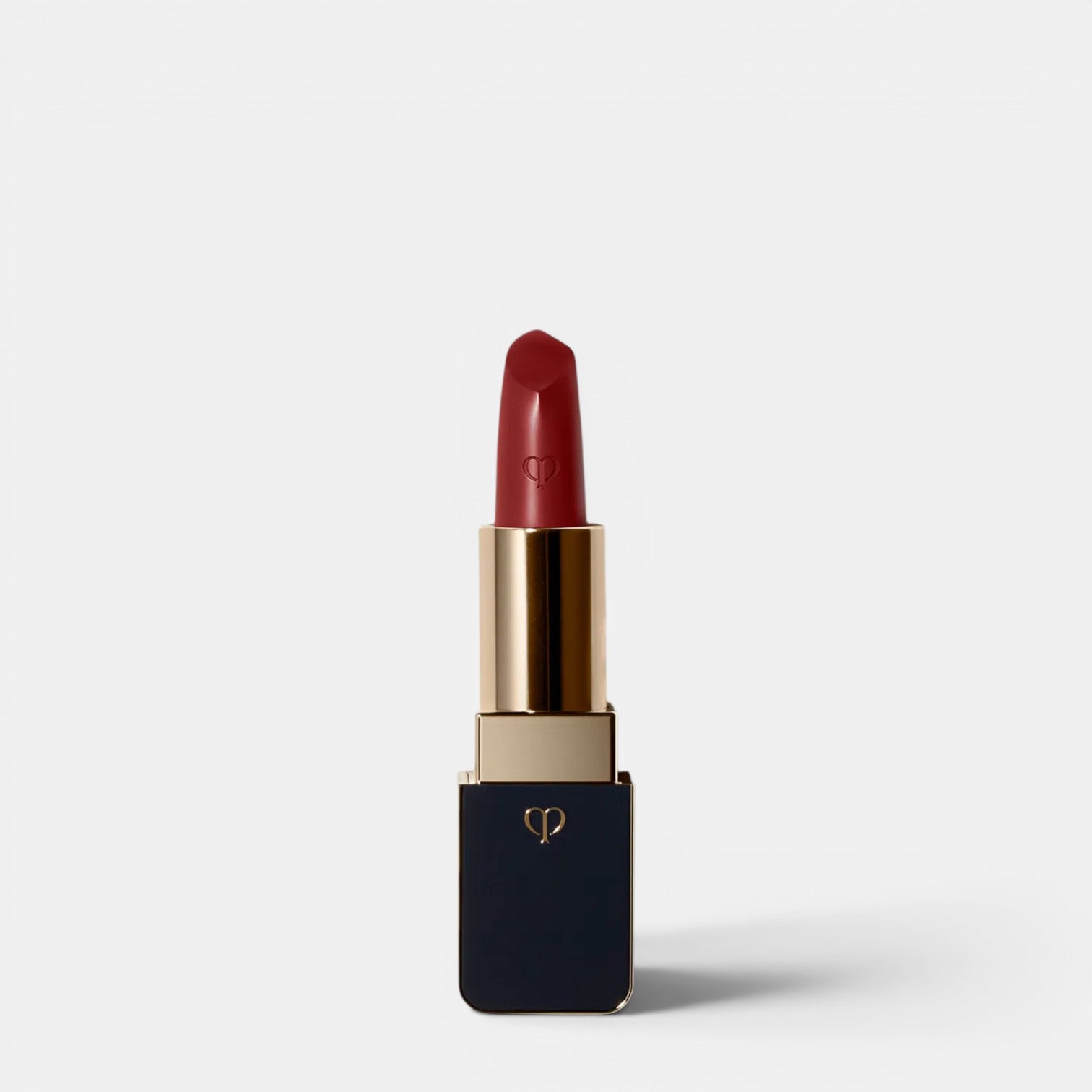 Shop Rescue Spa luxurious satin lipstick in a deep red shade with a gold and navy case.